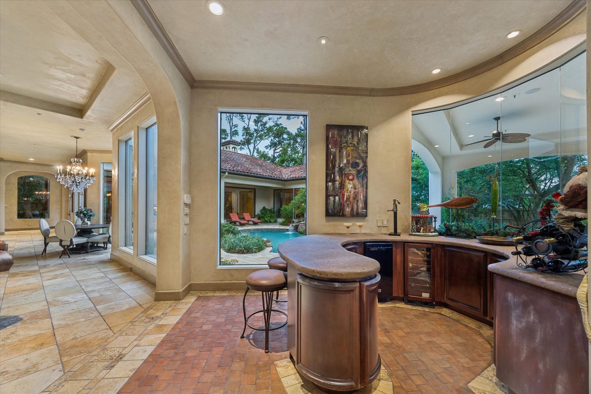 2 Lacewood Lane, Piney Point Village, TX 77024 Entertaining bar area with custom cabinetry, poolside views, and easy flow to the den and outdoor living spaces.