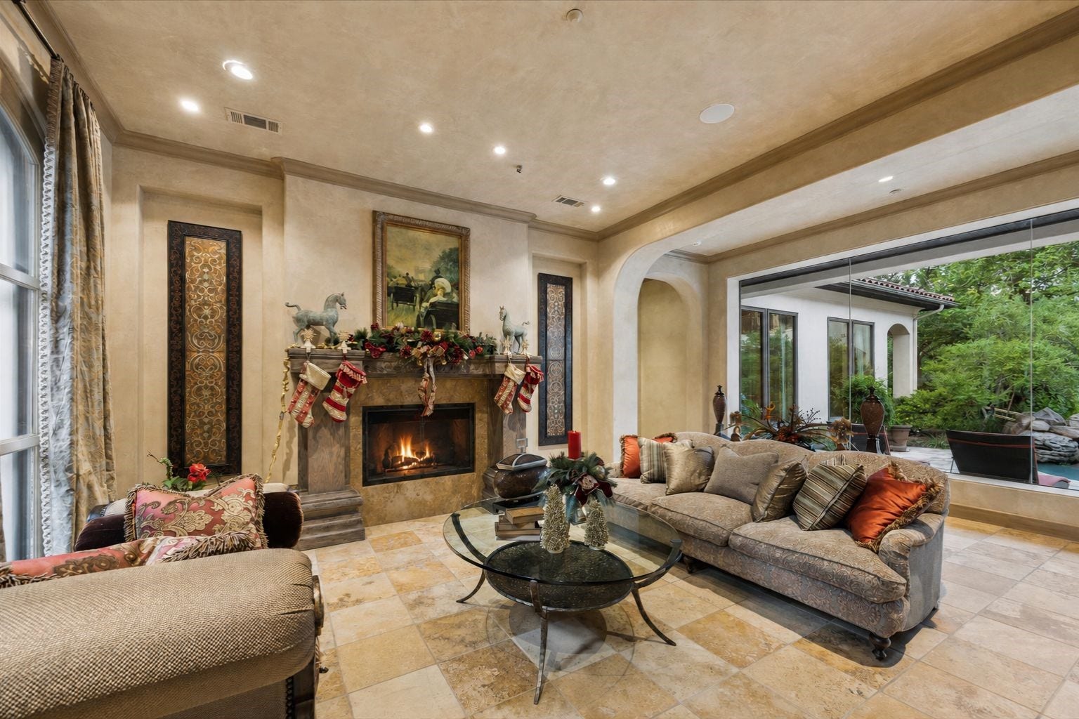 2 Lacewood Lane, Piney Point Village, TX 77024 Elegant formal living room with fireplace, warm stone flooring, and expansive views to the private outdoor living spaces.
**Formal living room with fireplace, warm stone flooring, and expansive views to the private grounds and outdoor living areas.**
More luxury:
**Elegant formal living room featuring a fireplace, arched architectural details, and floor-to-ceiling views of the lush outdoor settingElega