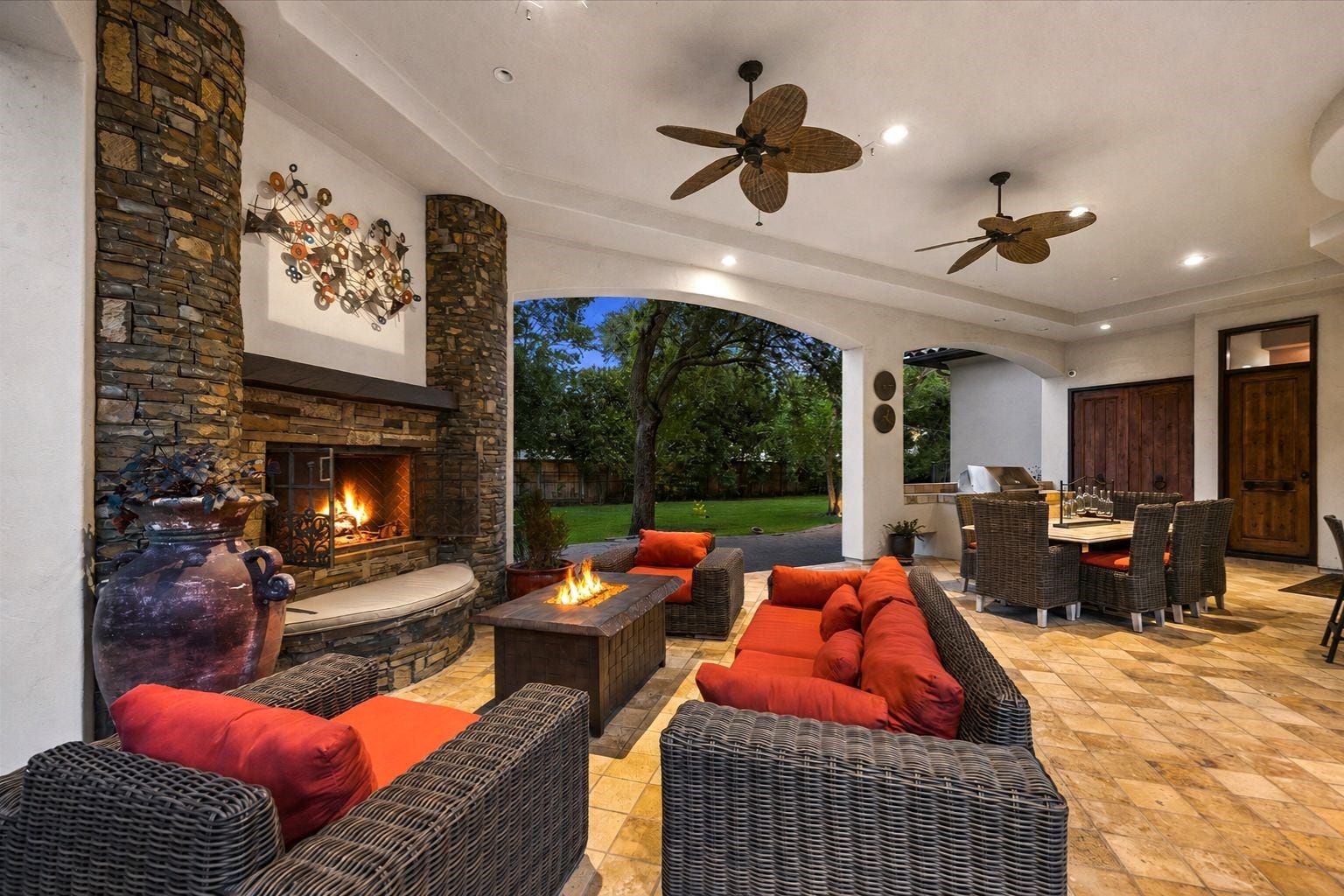 2 Lacewood Lane, Piney Point Village, TX 77024 Inviting loggia lounge featuring a stone fireplace, comfortable seating, and seamless connection to the surrounding outdoor spaces.