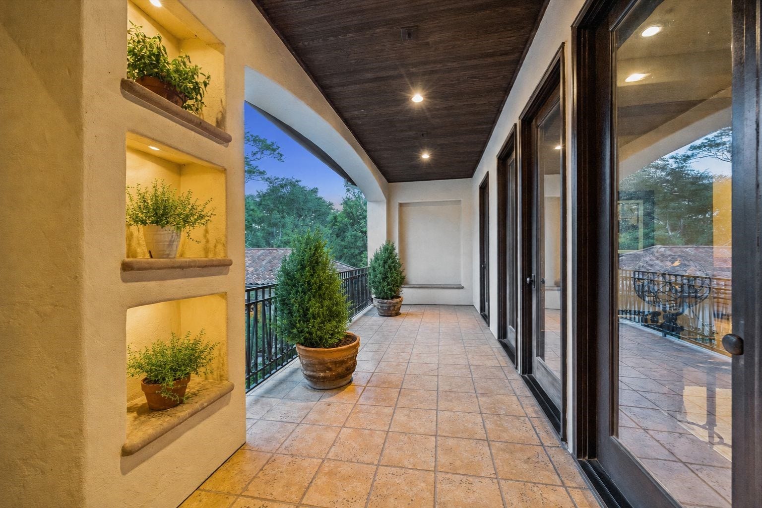 2 Lacewood Lane, Piney Point Village, TX 77024 Covered balcony off the study with serene pool views, creating a quiet upstairs outdoor retreat.