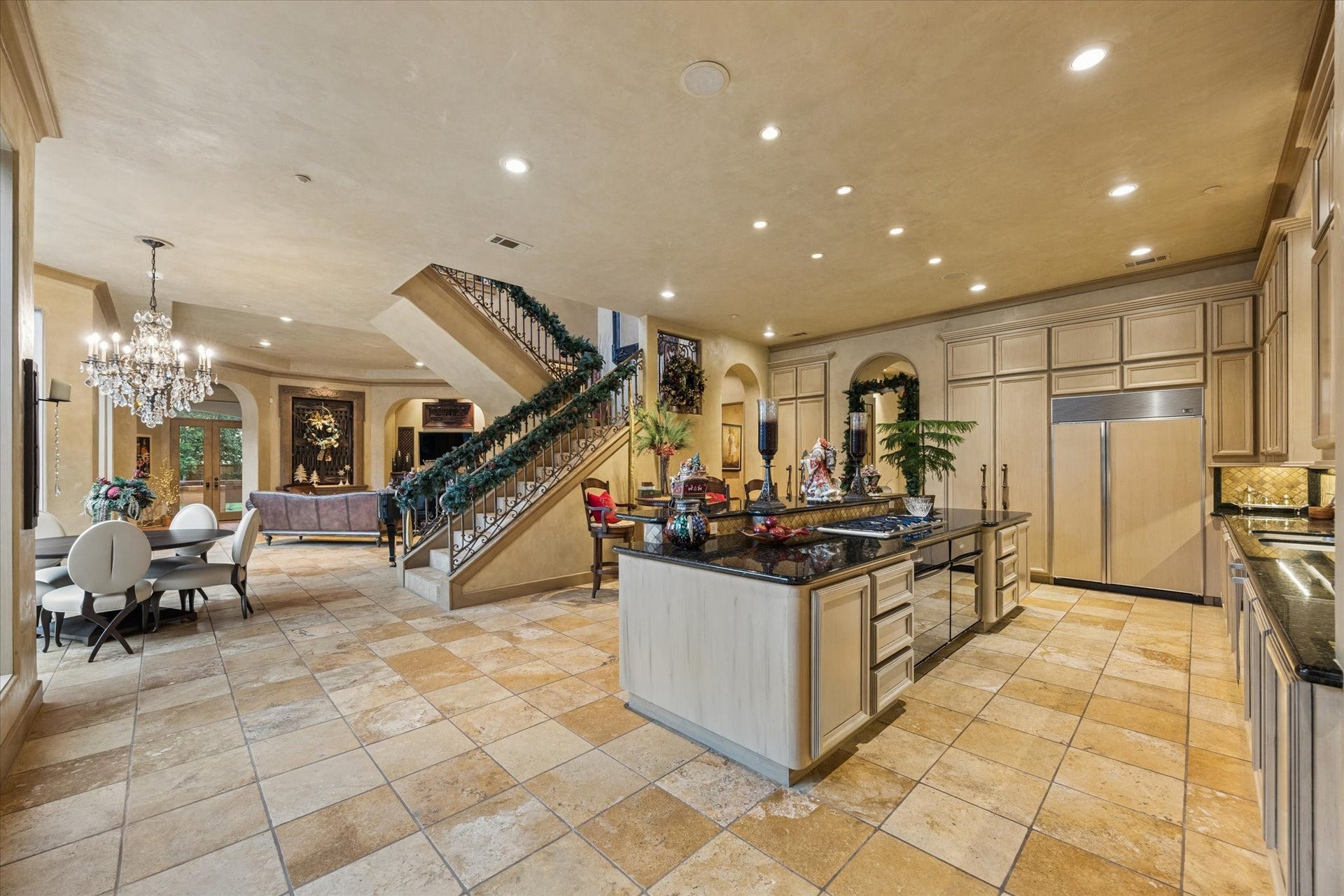 2 Lacewood Lane, Piney Point Village, TX 77024 Grand kitchen designed for entertaining, with a large center island, custom cabinetry, and open flow to the breakfast area and den.