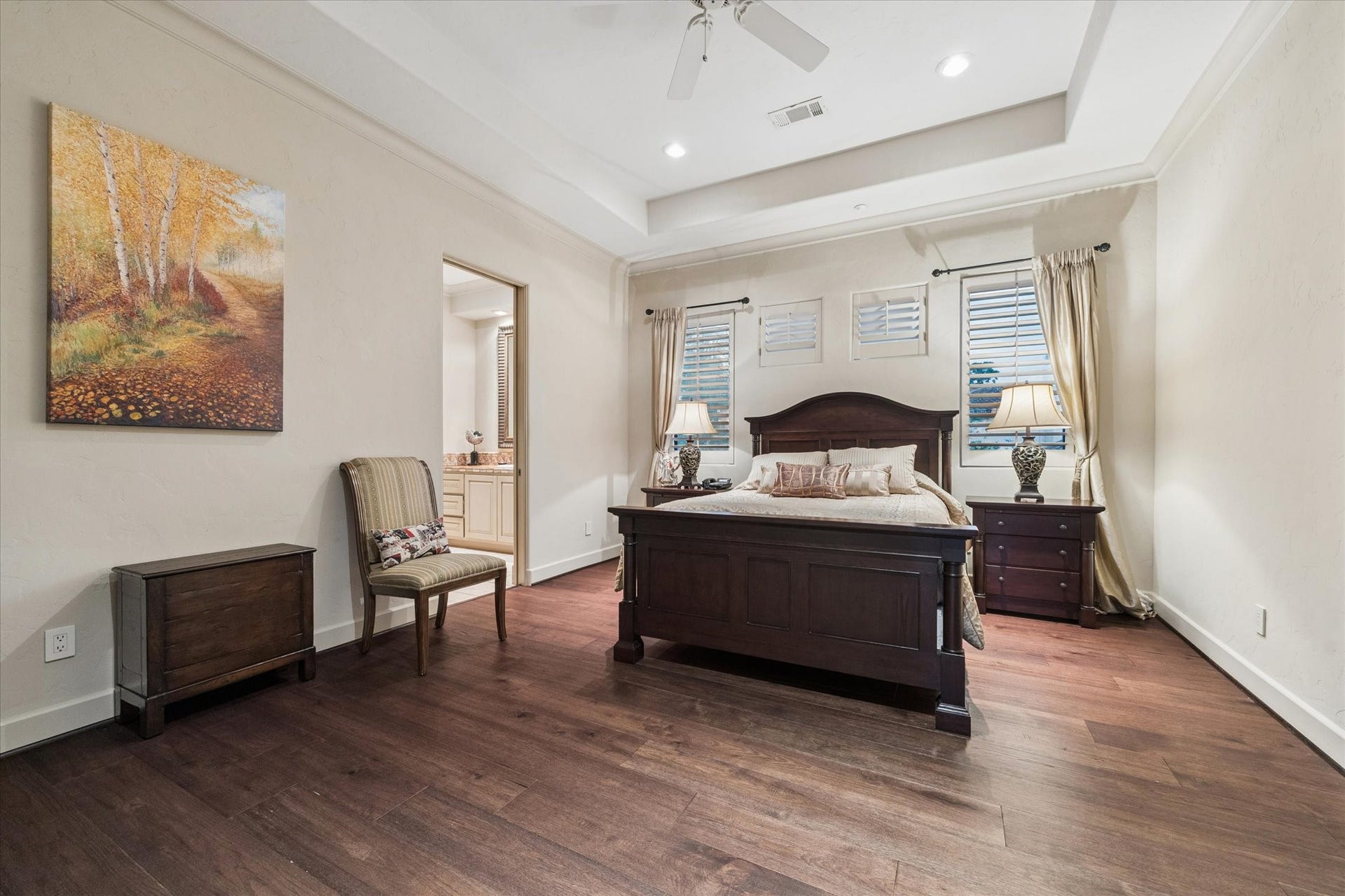 2 Lacewood Lane, Piney Point Village, TX 77024 Generous upstairs suite with rich wood flooring, tray ceiling detail, private balcony access, and en-suite bath.