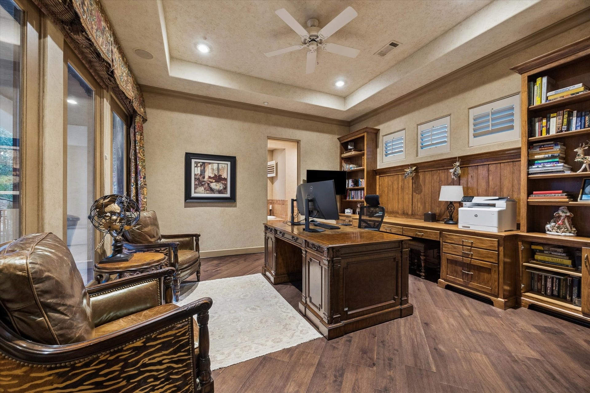 2 Lacewood Lane, Piney Point Village, TX 77024 Versatile upstairs bedroom or private study featuring rich wood flooring, built-in shelving, and a refined tucked-away setting.