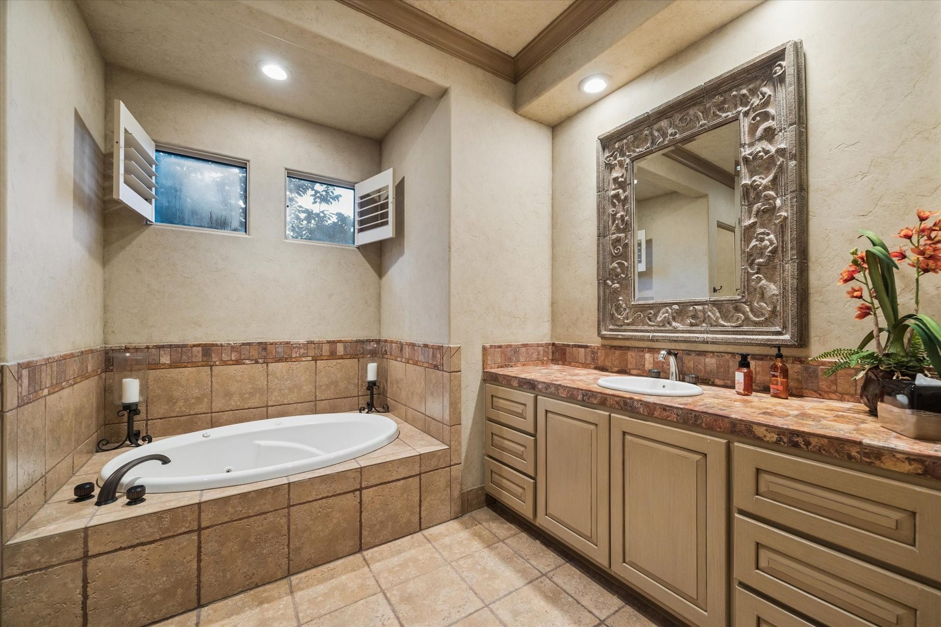 2 Lacewood Lane, Piney Point Village, TX 77024 Private en-suite bath featuring a soaking tub, custom vanity, and warm Mediterranean-inspired tile detail.