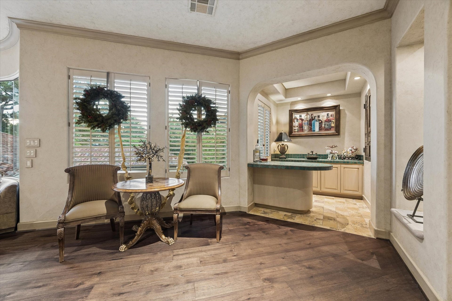 2 Lacewood Lane, Piney Point Village, TX 77024 Upstairs landing continues into a charming sitting area with wet bar, warm wood flooring, and elegant arched entry.