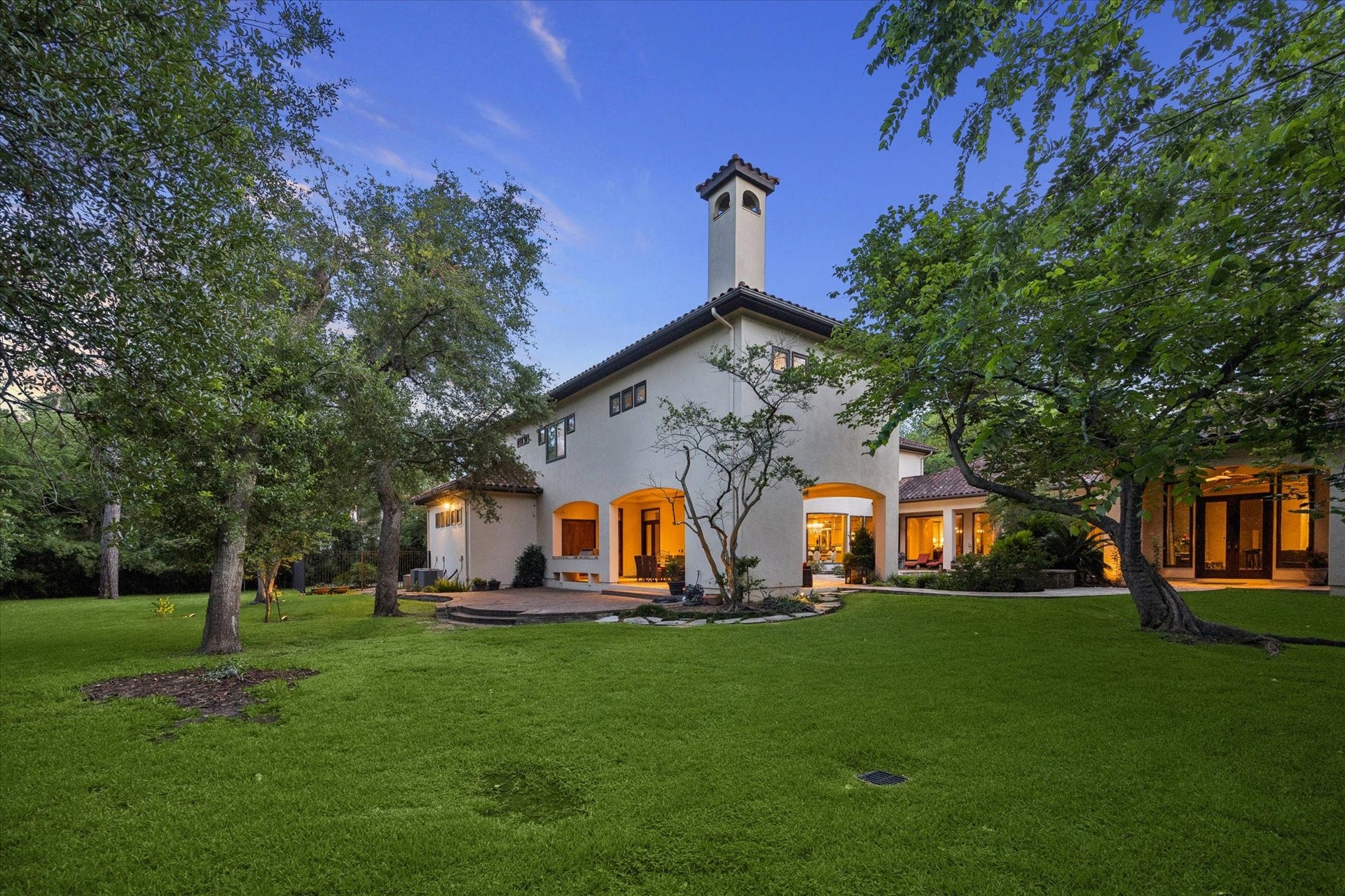 2 Lacewood Lane, Piney Point Village, TX 77024 Expansive rear grounds framed by mature trees, showcasing the homes private estate setting on a 40,590 sq. ft. lot.