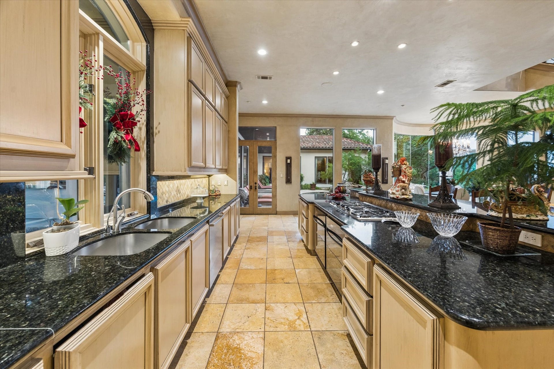 2 Lacewood Lane, Piney Point Village, TX 77024 Designed for everyday living and entertaining, the kitchen offers extensive prep space, custom cabinetry, and direct flow to the outdoor areas.