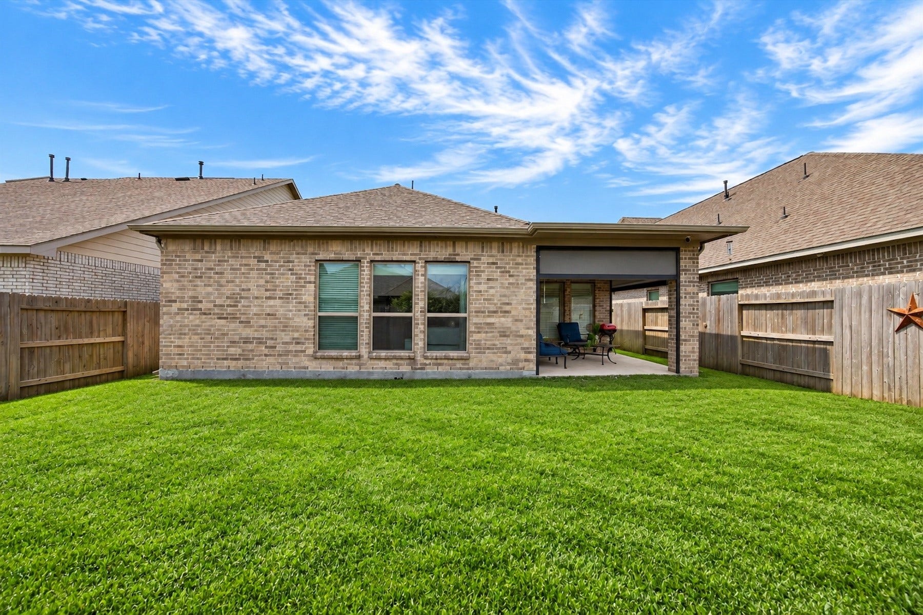 23026 Needlegrass Road, Katy, TX 77493 Backyard views showcasing the covered patio and spacious lawn.