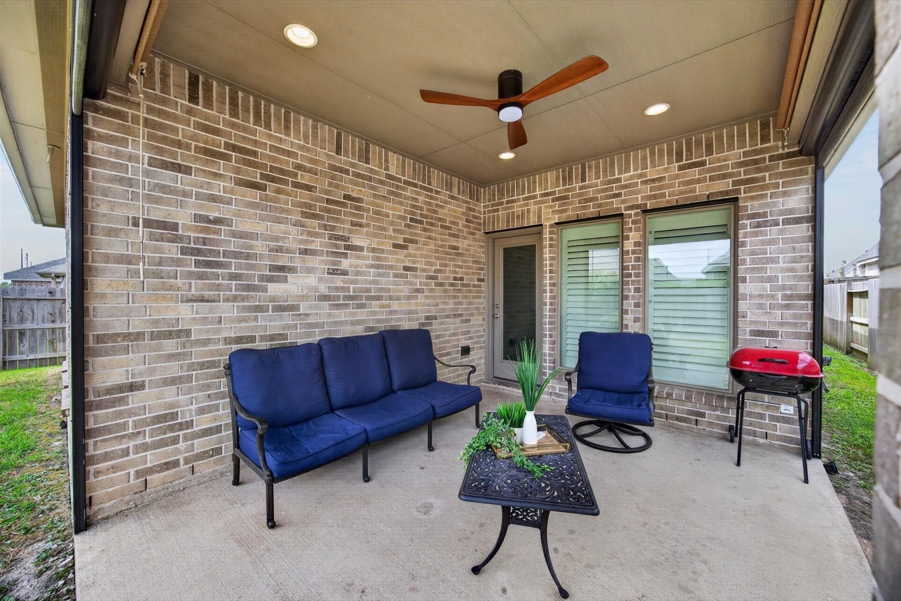 23026 Needlegrass Road, Katy, TX 77493 Covered patio featuring a custom drop shade for year-round comfort.