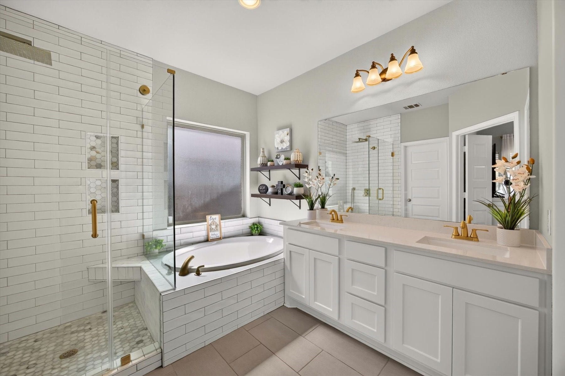 23026 Needlegrass Road, Katy, TX 77493 Primary bath with dual vanities, garden tub, and separate glass shower.