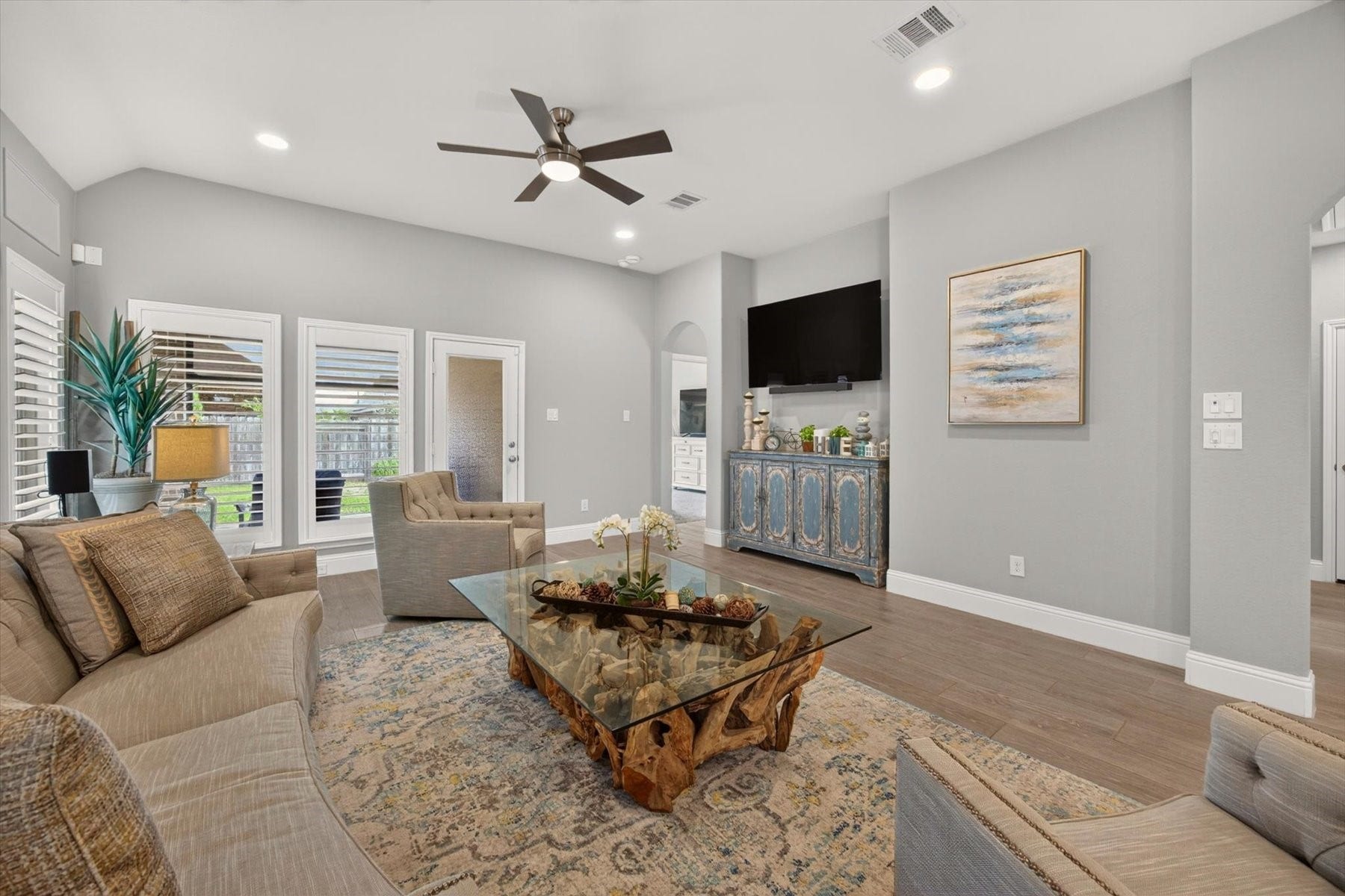 23026 Needlegrass Road, Katy, TX 77493 Spacious family room featuring large windows with custom shutters and backyard views.