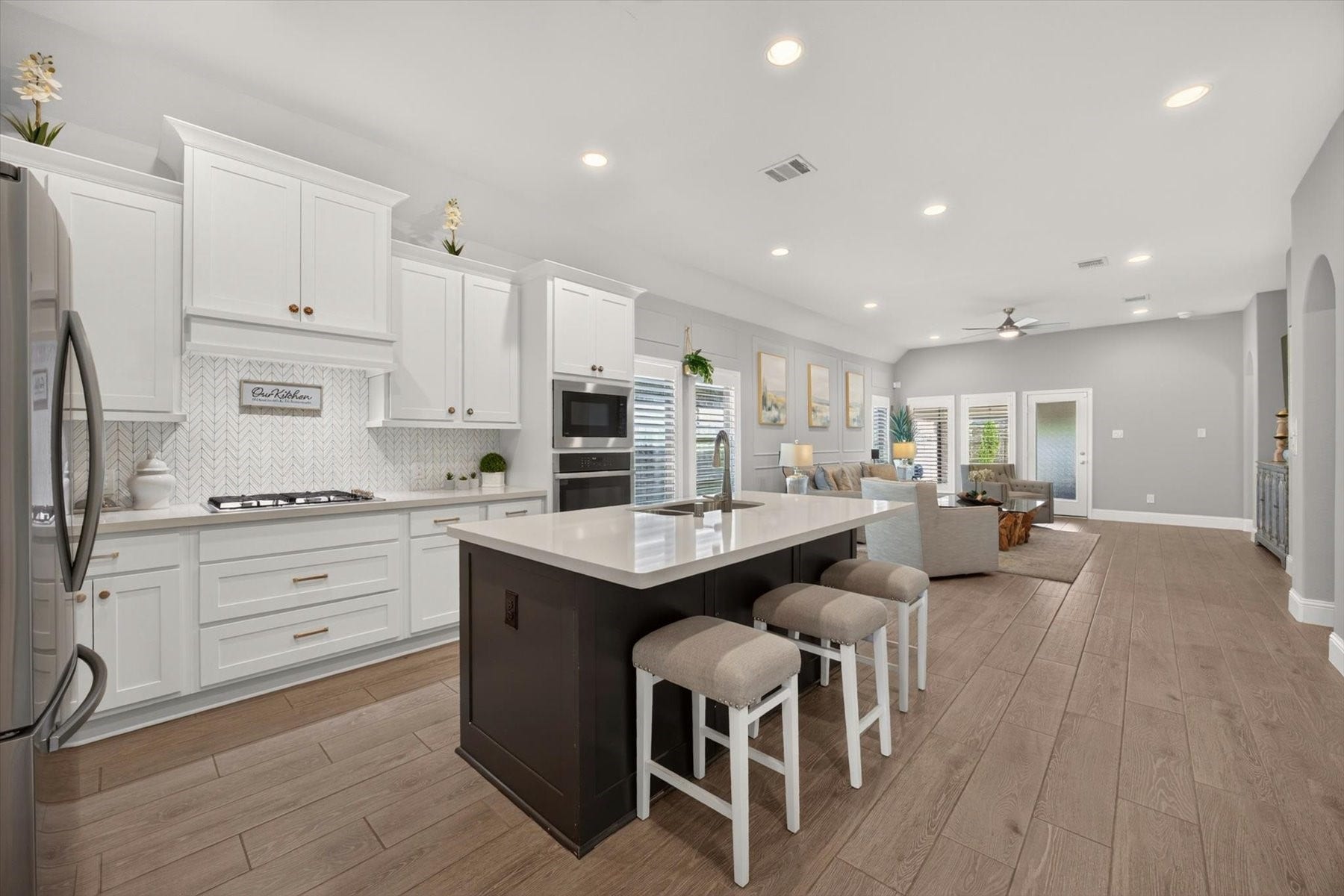 23026 Needlegrass Road, Katy, TX 77493 Spacious kitchen with modern herringbone backsplash and generous cabinet storage.