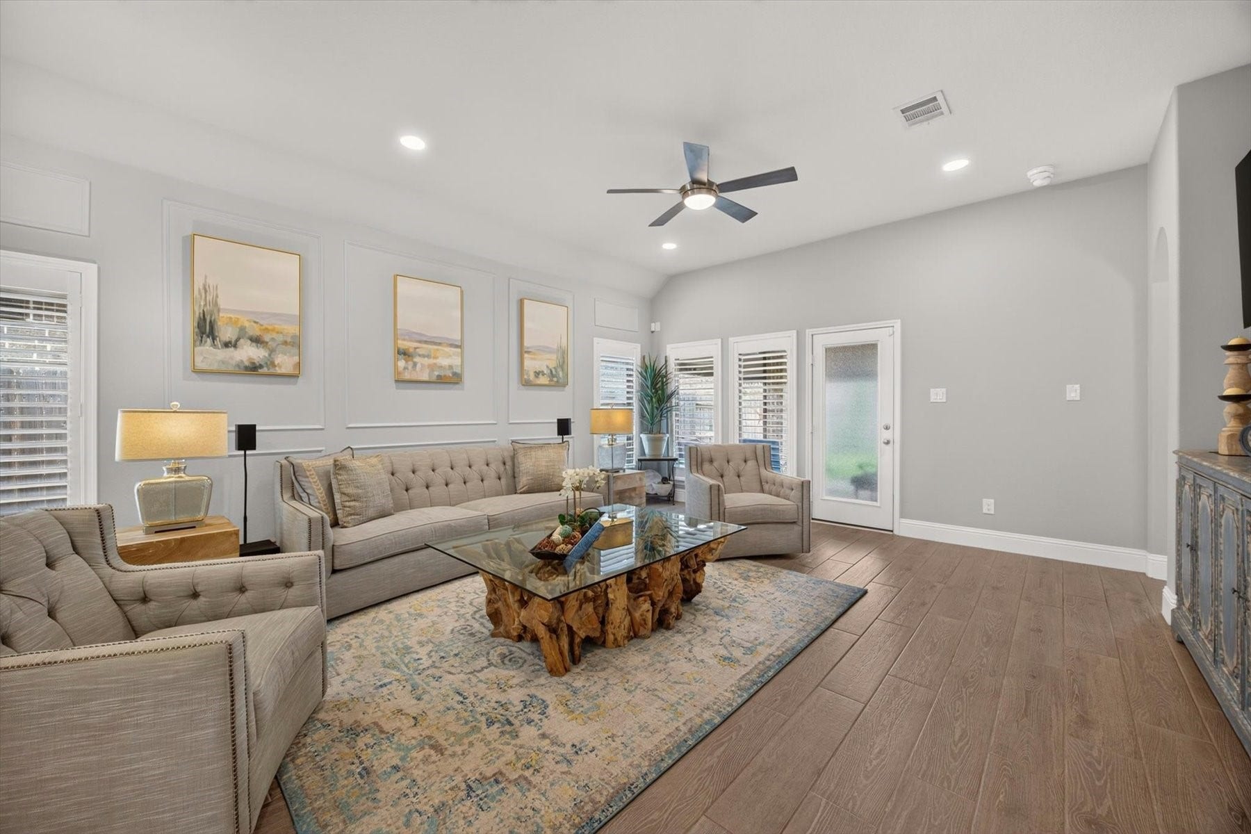 23026 Needlegrass Road, Katy, TX 77493 Light-filled family room with views of the backyard and covered patio. Elegant wall moldings and custom shutters throughout the home.