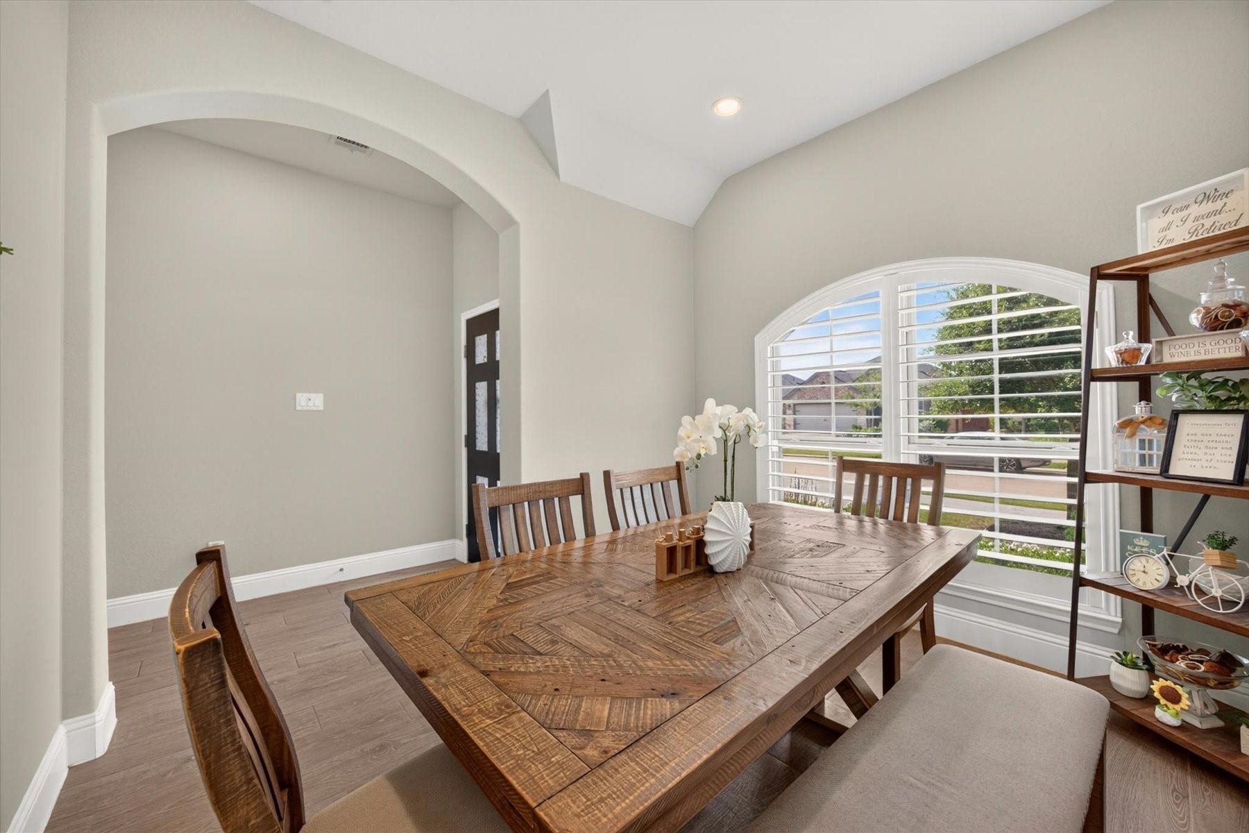 23026 Needlegrass Road, Katy, TX 77493 Bright dining room showcasing custom shutters and a beautiful arched window.