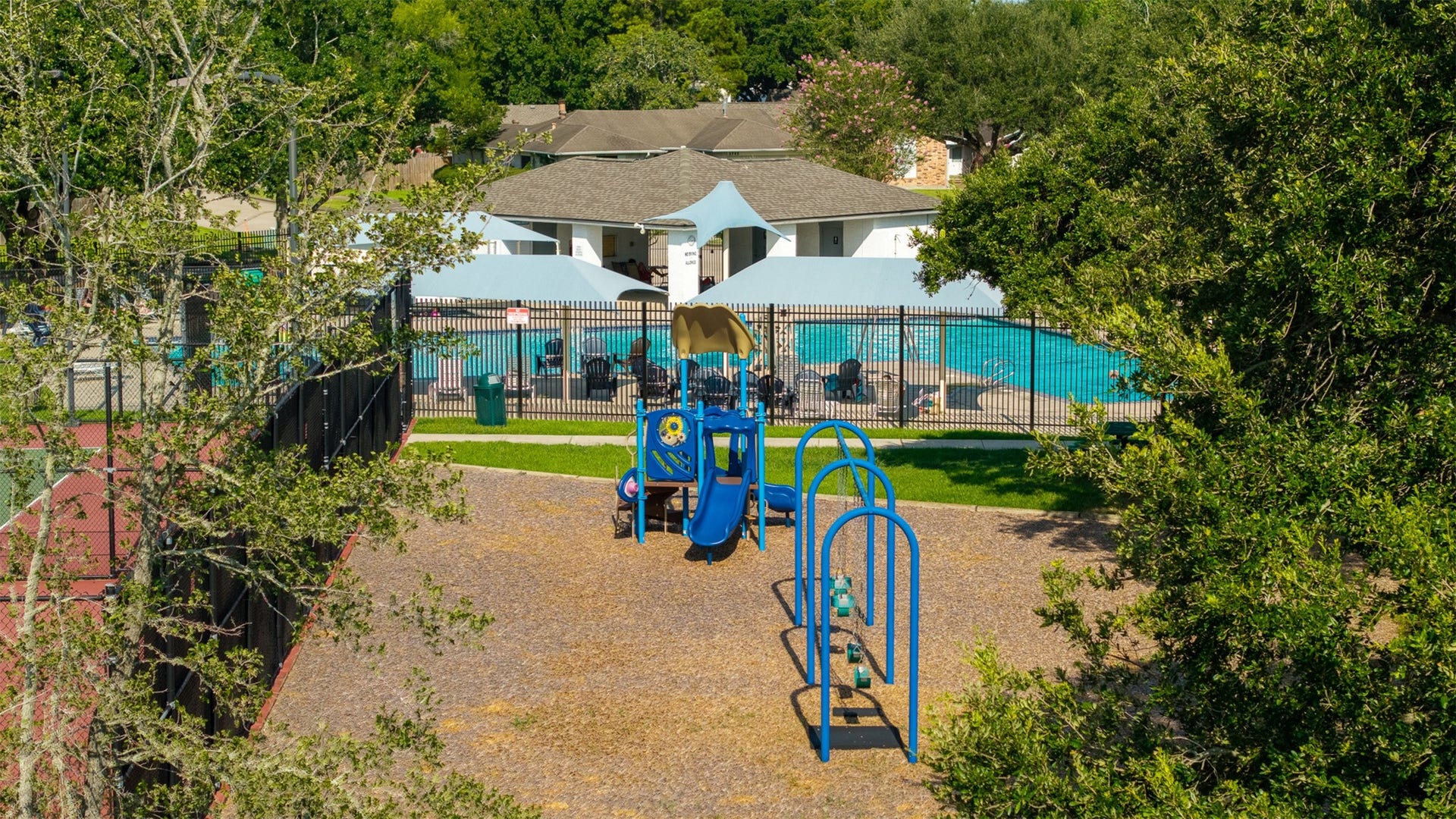 1118 Wentworth Drive, Pearland, TX 77584 Perched beside the tennis courts, this vibrant play area features a colorful jungle gym, swing set, and a soft mulch surface. Beyond the perimeter fence, residents enjoy access to a shaded community pool and pavilion.