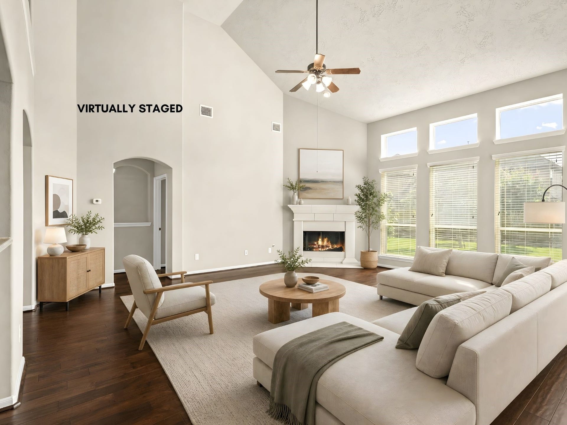 5307 Amber Sky Lane, Rosharon, TX 77583 Soaring two-story ceilings and a striking gas fireplace anchor this beautifully virtually staged family room, designed to inspire grand-scale gatherings and relaxed evenings alike.