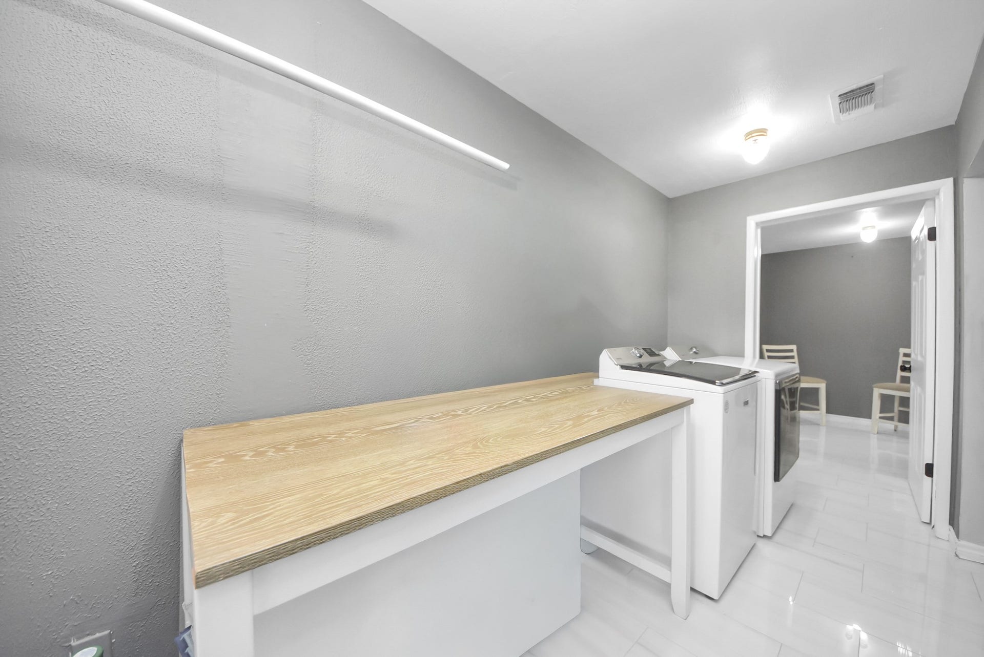 5241 County Road 819, Brazoria, TX 77422 This large laundry room has a practical folding table and storage space.