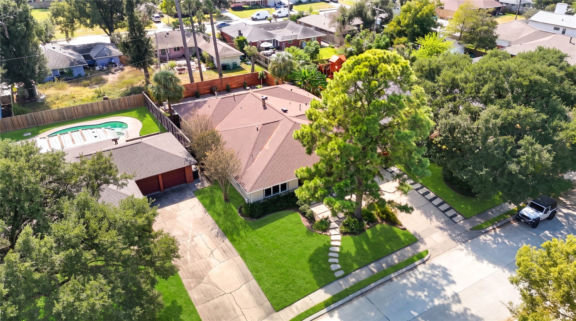 6211 Grovewood Lane, Houston, TX 77008 An aerial view from the front shows the home's single-story footprint, landscaped lot and mature trees.