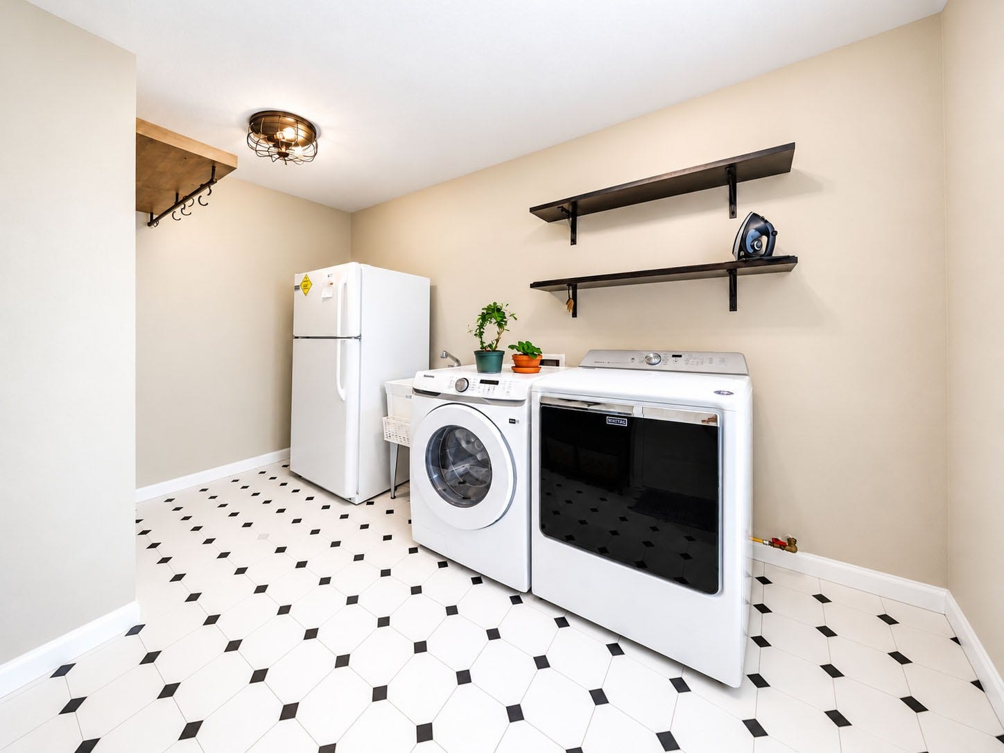 6211 Grovewood Lane, Houston, TX 77008 Spacious laundry room with patterned tile flooring and open wall shelving.