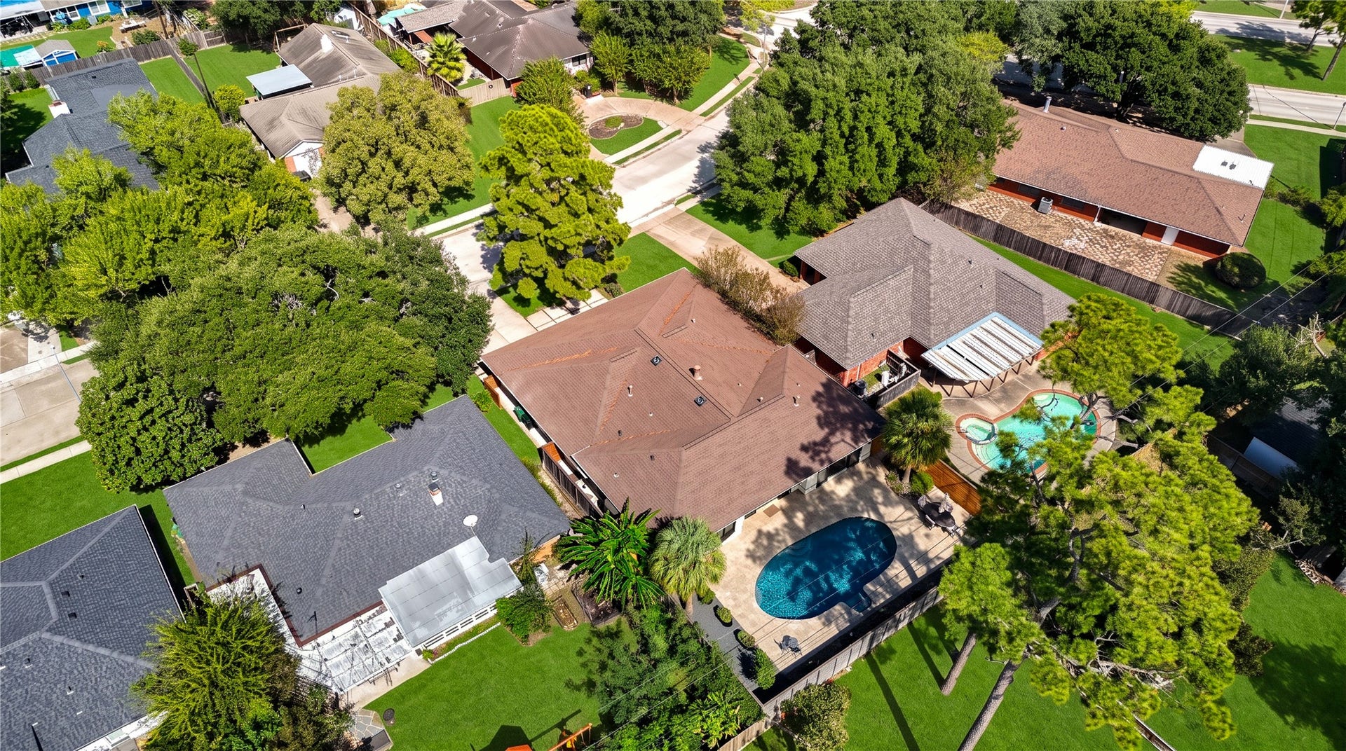 6211 Grovewood Lane, Houston, TX 77008 An aerial view of the rear of the home shows the pool, yard and surrounding mature tree canopy.