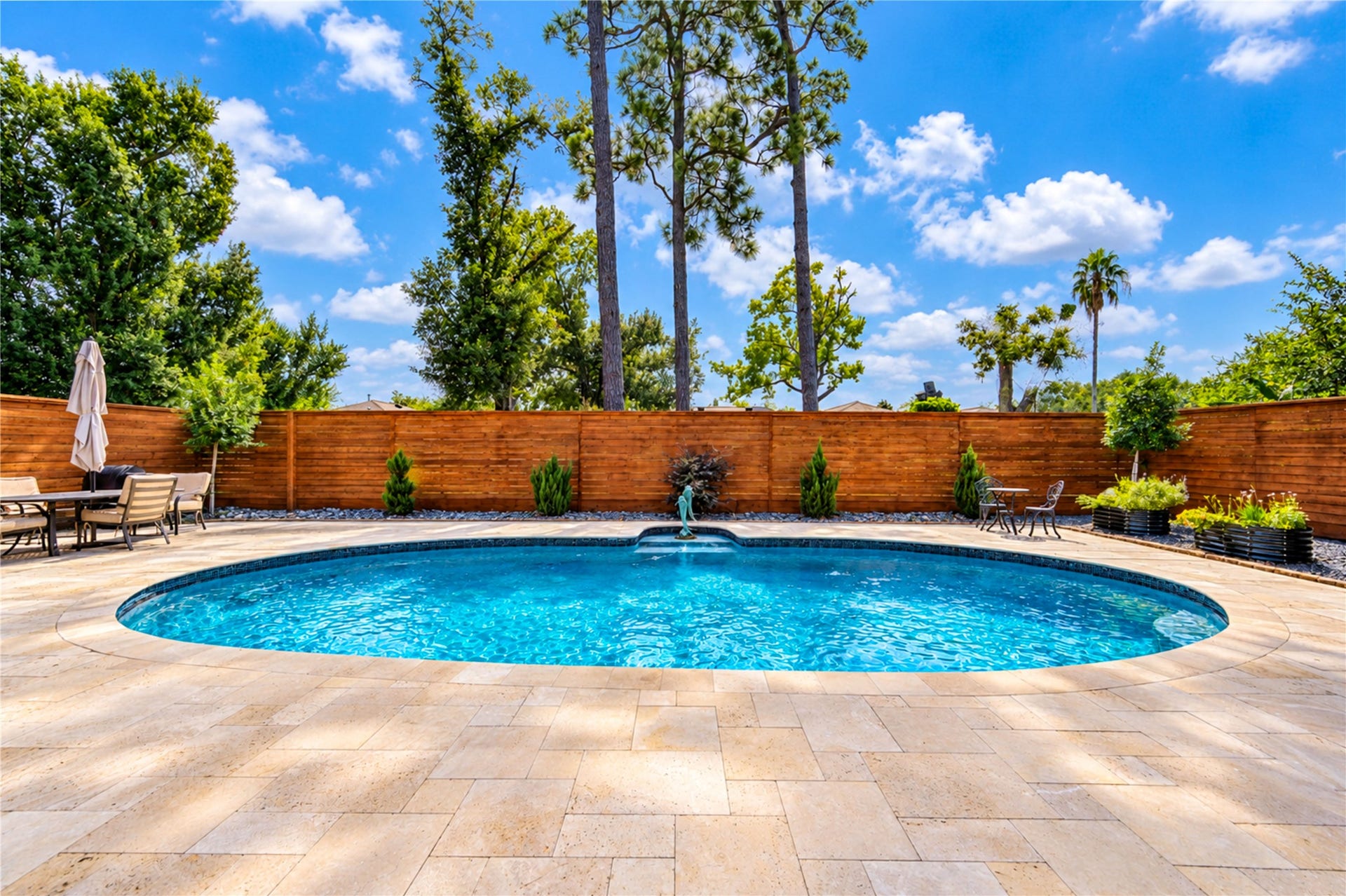 6211 Grovewood Lane, Houston, TX 77008 A beautiful gunite pool, expansive travertine decking and mature landscaping create an inviting backyard setting for outdoor living.