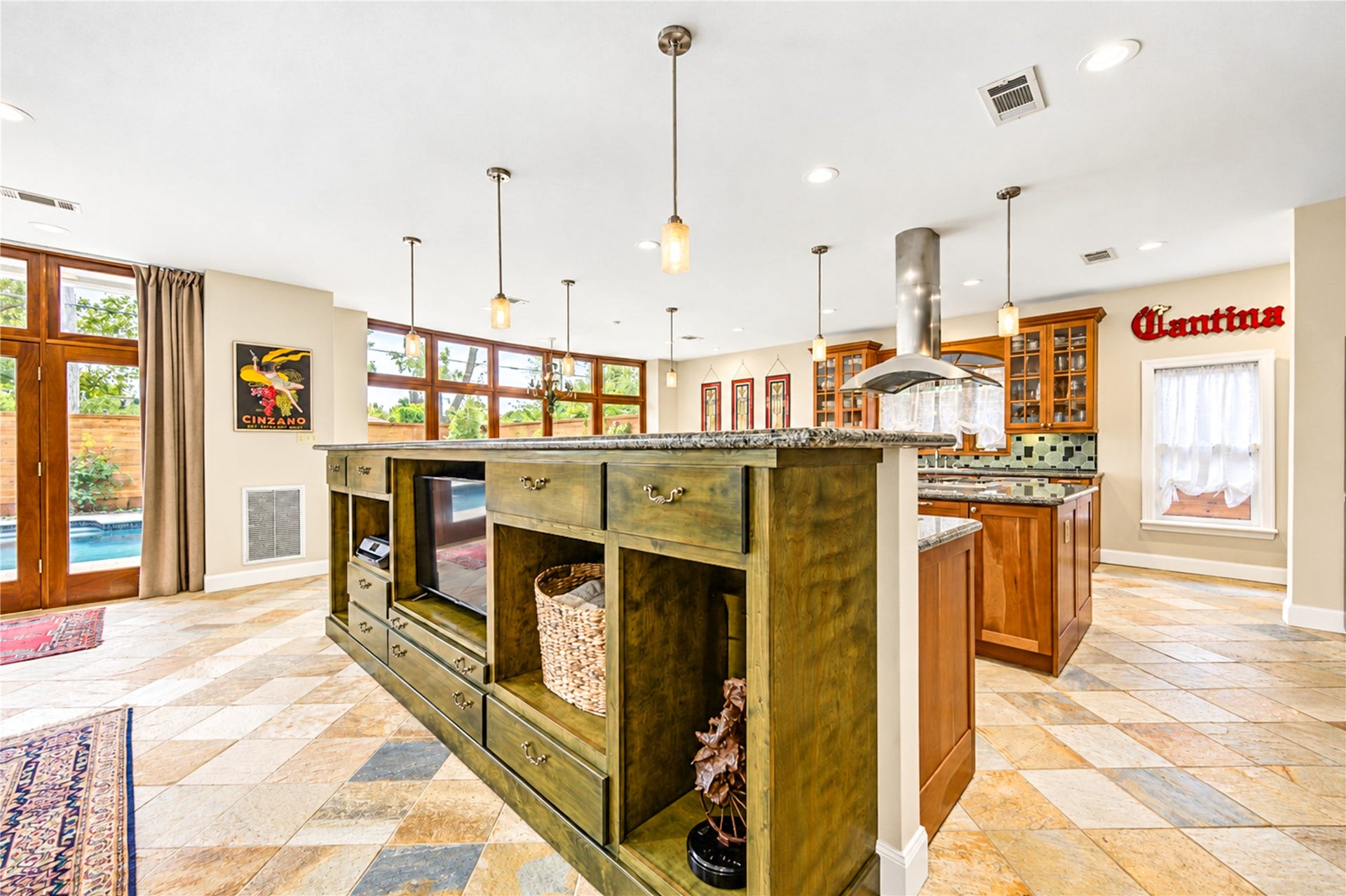 6211 Grovewood Lane, Houston, TX 77008 Stone flooring, rich wood cabinetry and an open plan join the family room and kitchen in one light-filled space.