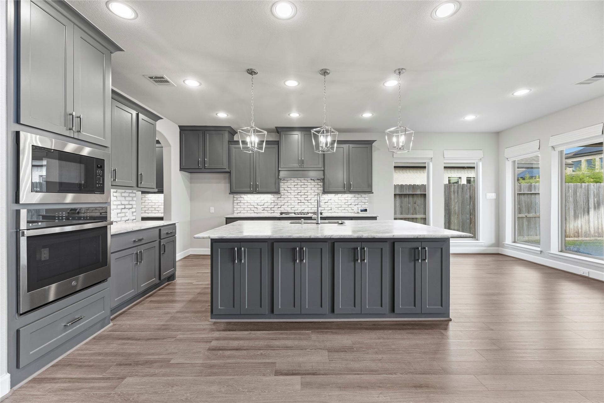 9511 Shaded Tree Drive, Missouri City, TX 77459 Quartzite island with sleek cabinetry and an abundance of storage space.