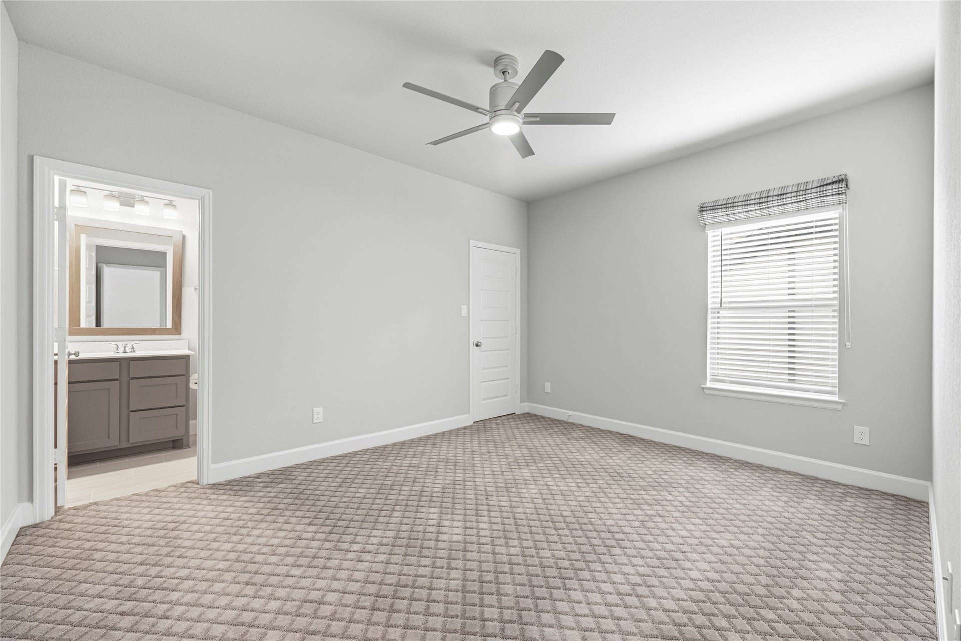 9511 Shaded Tree Drive, Missouri City, TX 77459 1 of 3 secondary bedrooms located upstairs, complete with plush carpet, large windows with privacy blinds, and a ceiling fan.