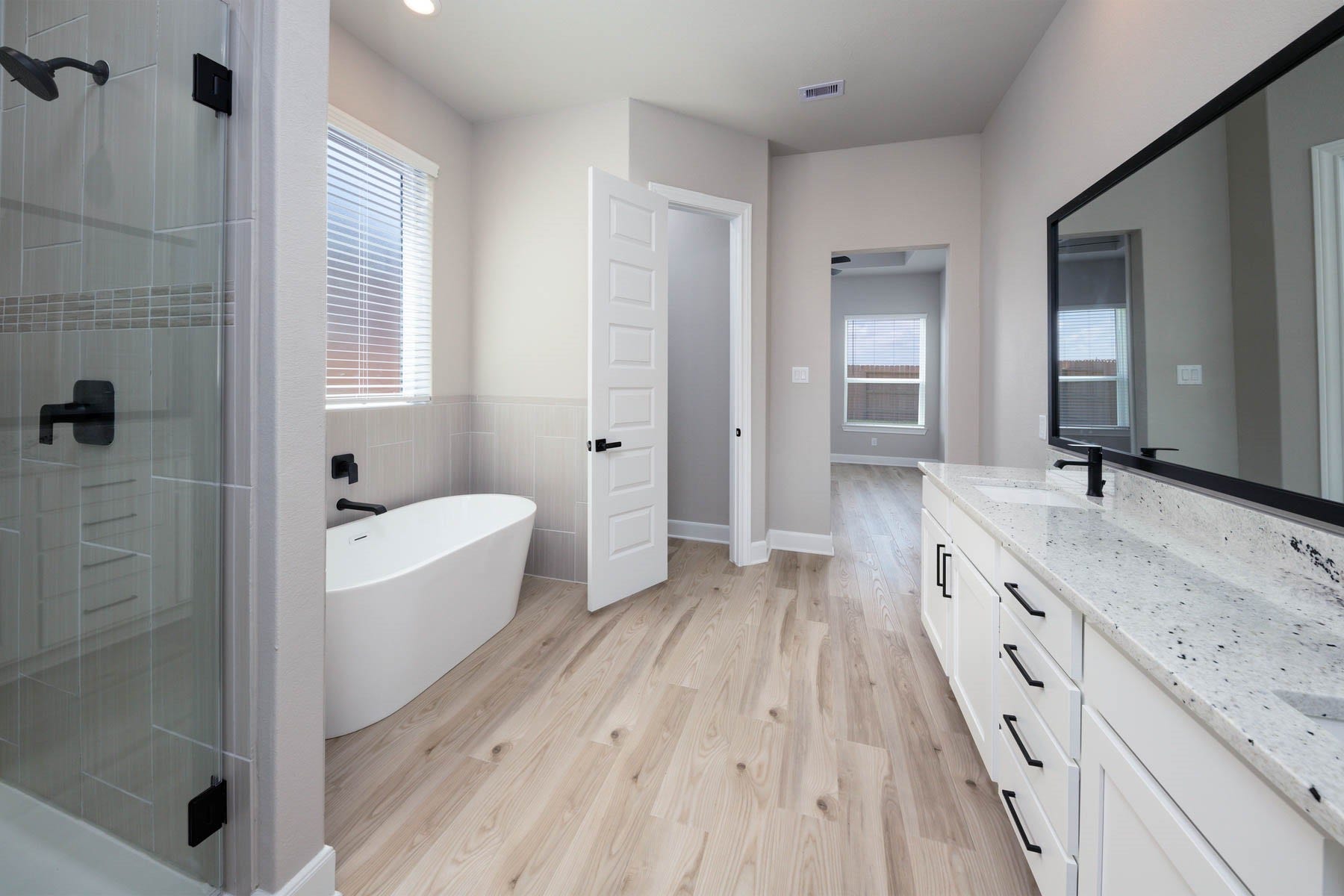10506 Sutter Creek Drive, Iowa Colony, TX 77583 Experience serenity in the en-suite bathroom, where a stylish vanity provides a focal point for the room, and a separate tub and shower combo offer the epitome of comfort and convenience. With its tranquil ambiance and thoughtful design, this private sanctuary is a haven for relaxation."