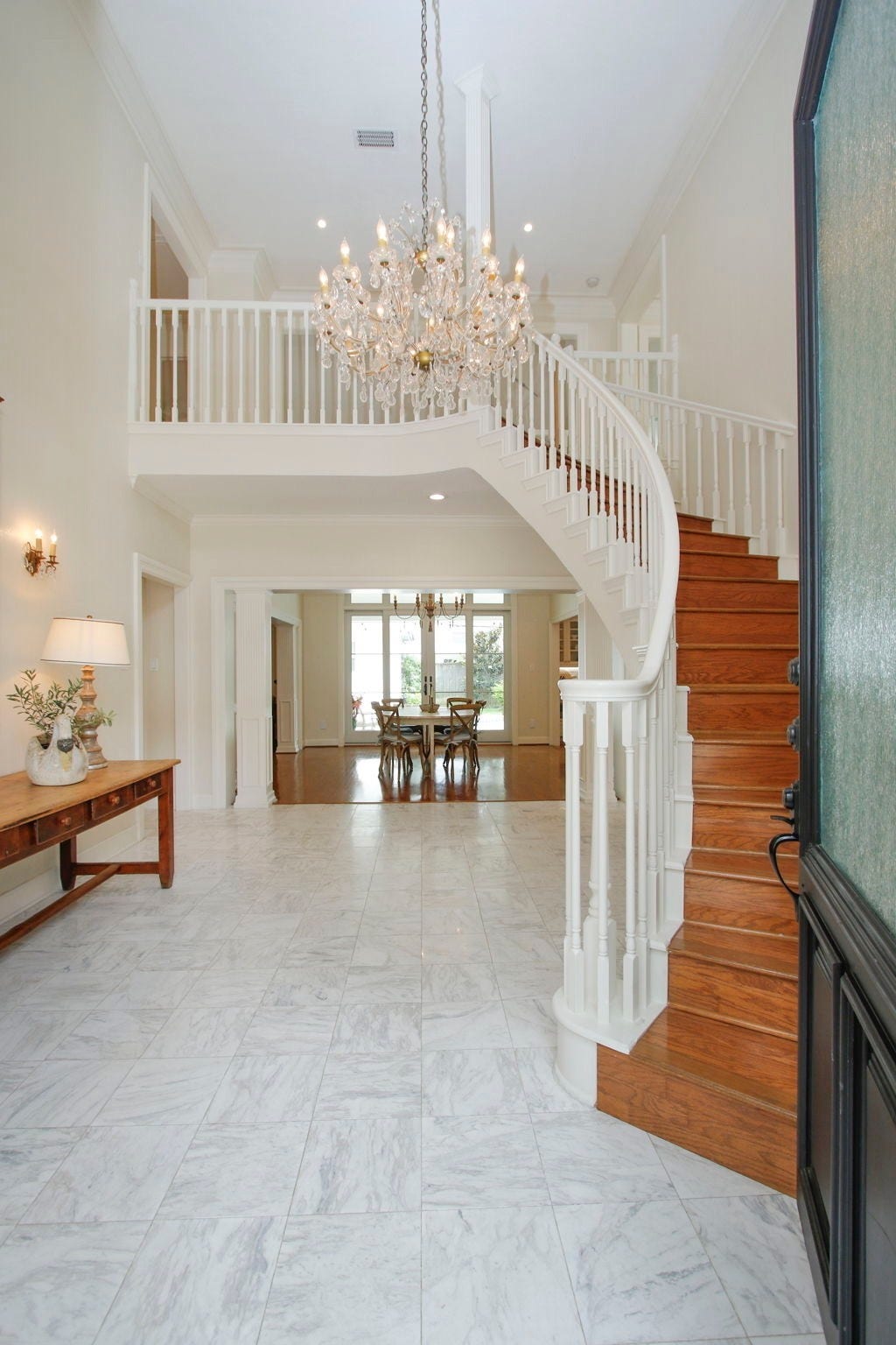 8515 Tranquil Park Drive, Spring, TX 77379 Elegant two-story foyer with original crystal chandelier and grand staircase leading to an open catwalk.