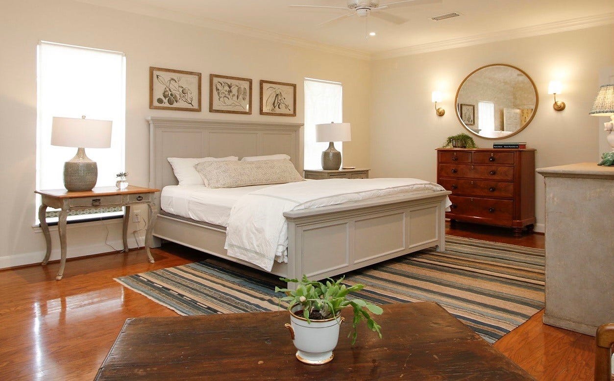 8515 Tranquil Park Drive, Spring, TX 77379 The primary bedroom is down a hallway from the formal living room and features wood floors.