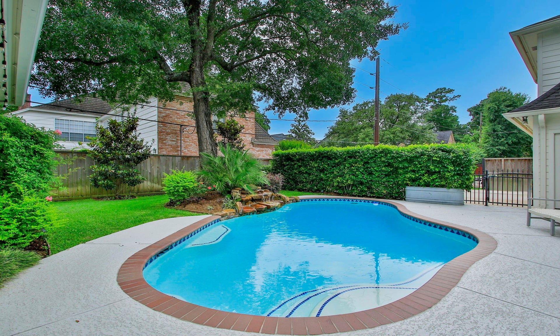 8515 Tranquil Park Drive, Spring, TX 77379 The pool features a rock waterfall and was recently resurfaced.
