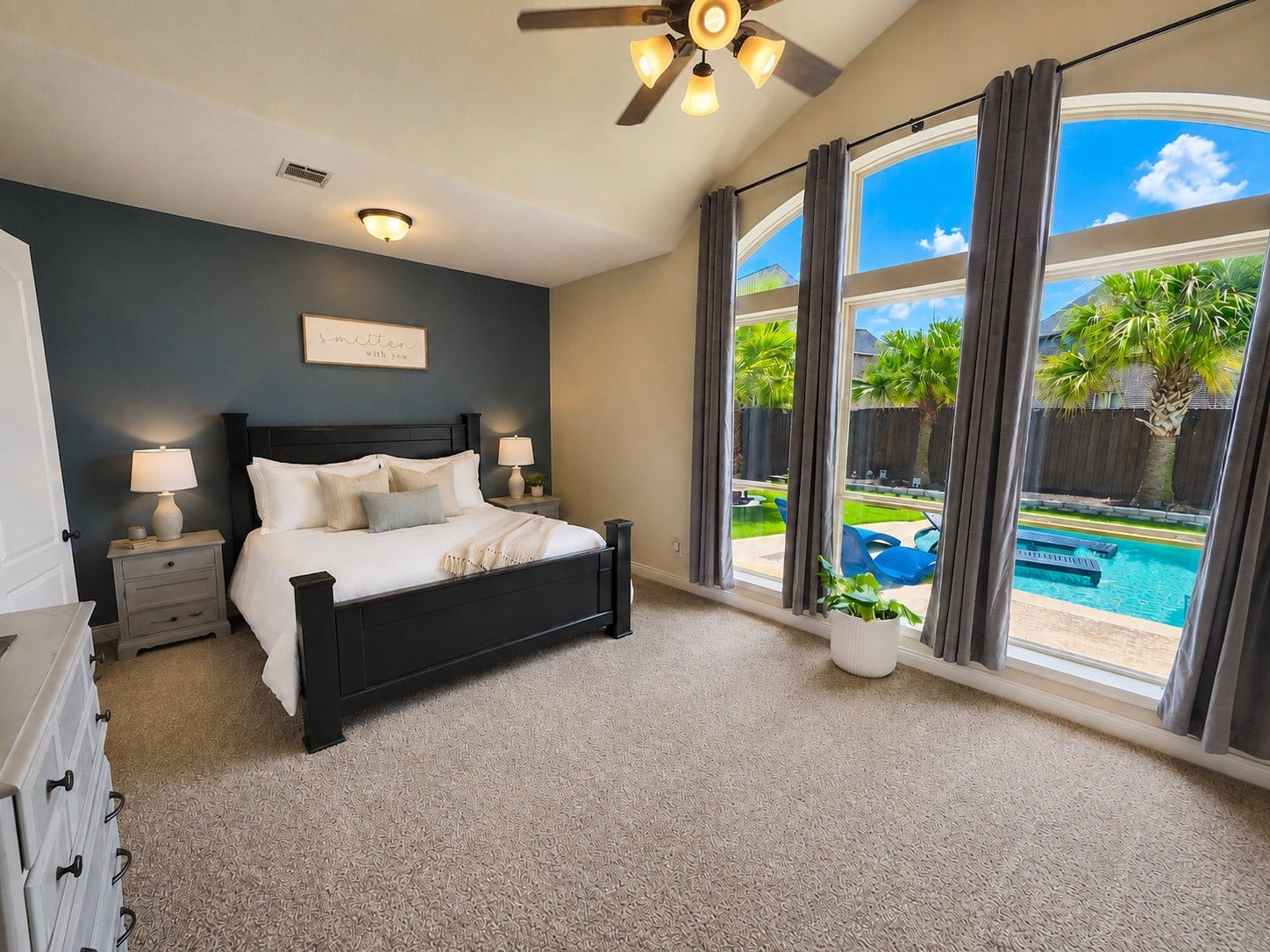 9723 Painted Stone Court, Cypress, TX 77433 Expansive primary bedroom with stunning backyard views through elegant picture windows.