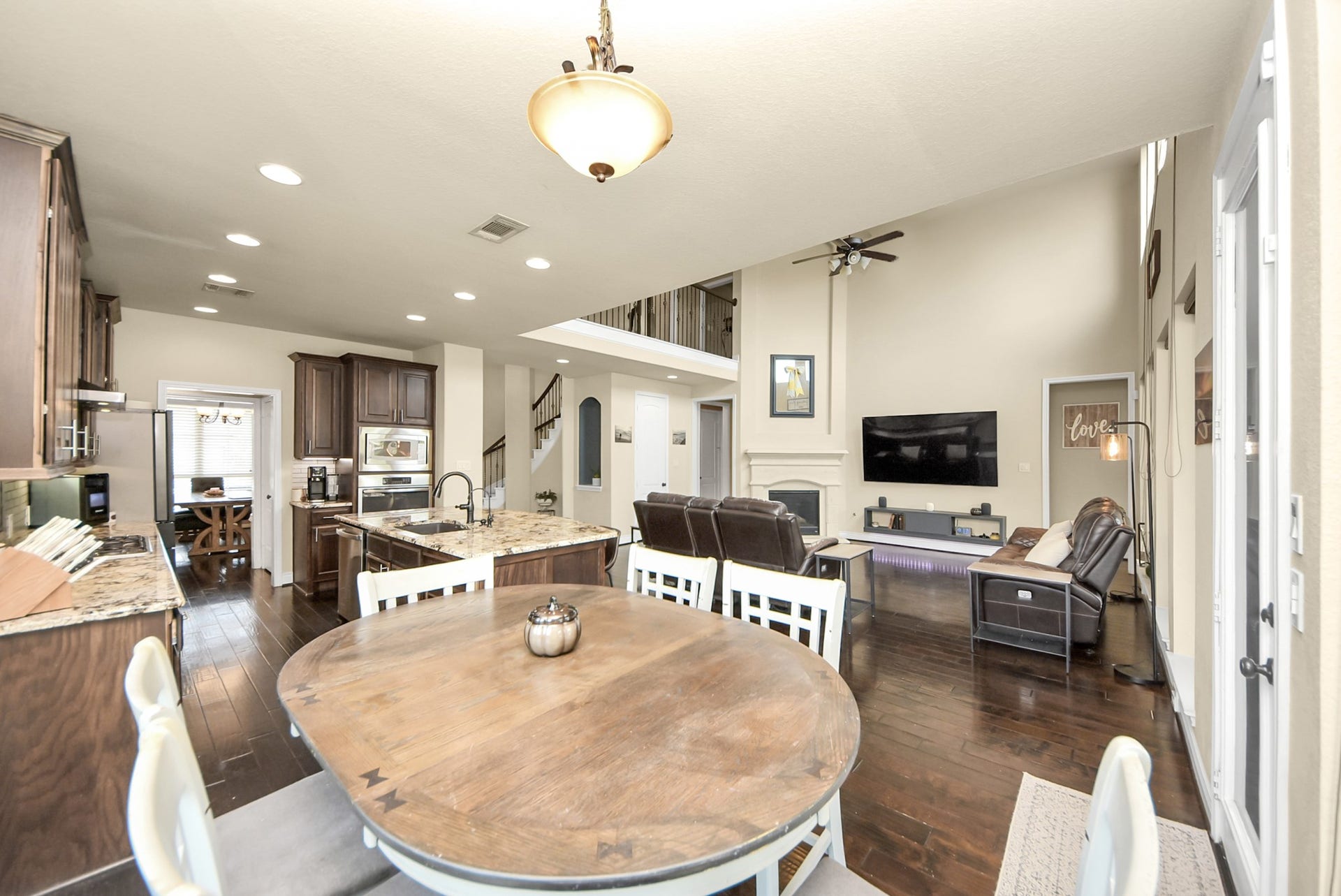 9723 Painted Stone Court, Cypress, TX 77433 Enjoy breakfast with serene views of the pool and lake.