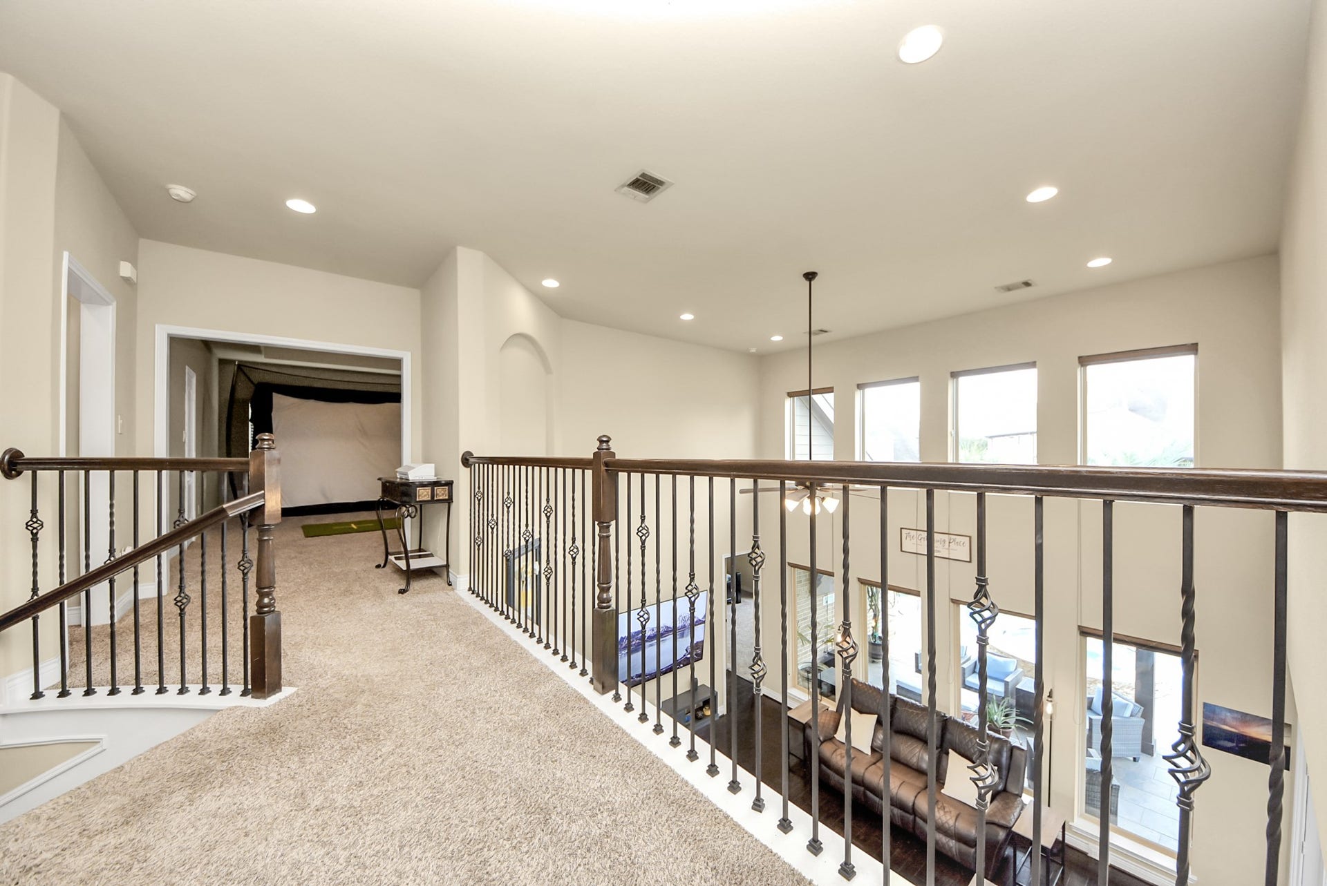 9723 Painted Stone Court, Cypress, TX 77433 The upper-level walkway seamlessly connects to the inviting game room and cozy bedroom 2.