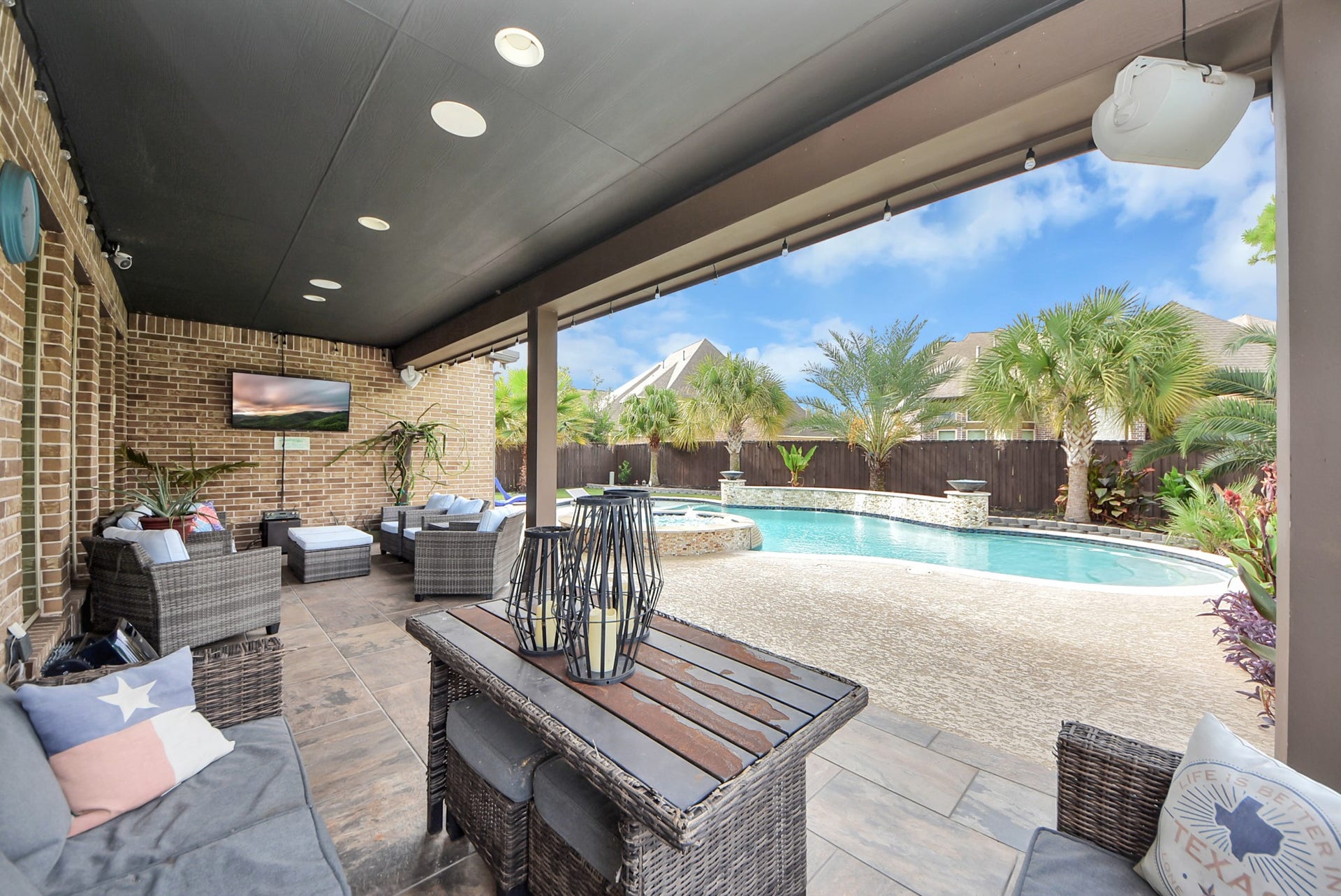 9723 Painted Stone Court, Cypress, TX 77433 Expansive back patio perfect for entertaining, with dual sitting areas and an ideal view for game day excitement.