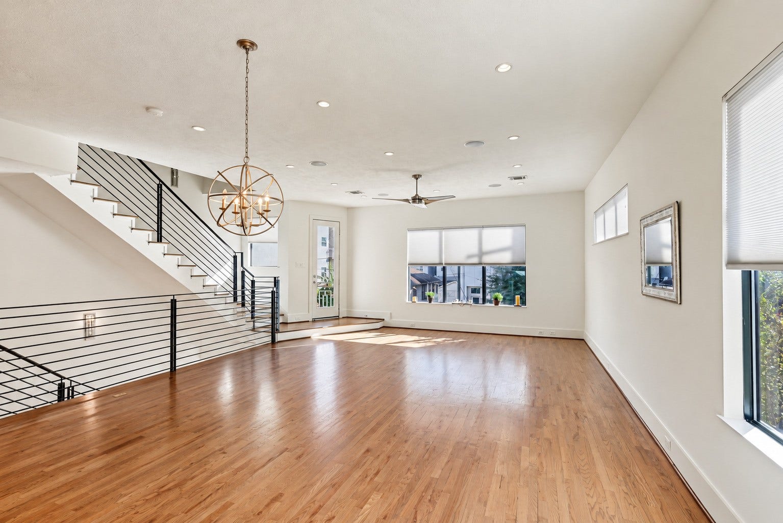 Gather, dine, and unwind across a light-filled main level tailored for effortless connection. Solid white oak flooring adds natural warmth to the open-concept living and dining areas, setting an inviting stage for both daily routines and lively entertaining.