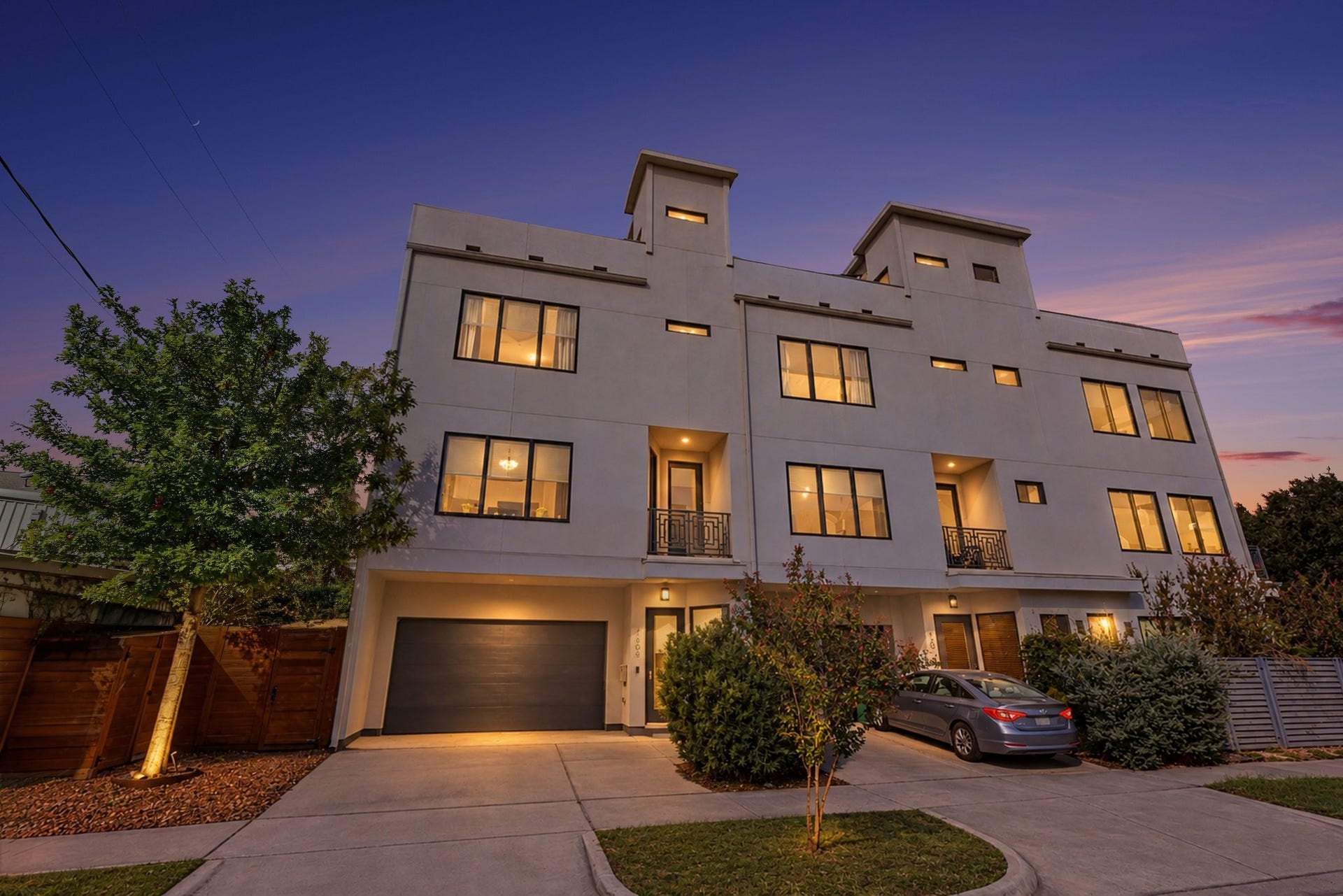 Located at 1808 Taft Street, this striking multi-level contemporary residence showcases bold geometric architecture characterized by clean lines, a smooth light-gray stucco facade, and distinctive rooftop tower volumes.