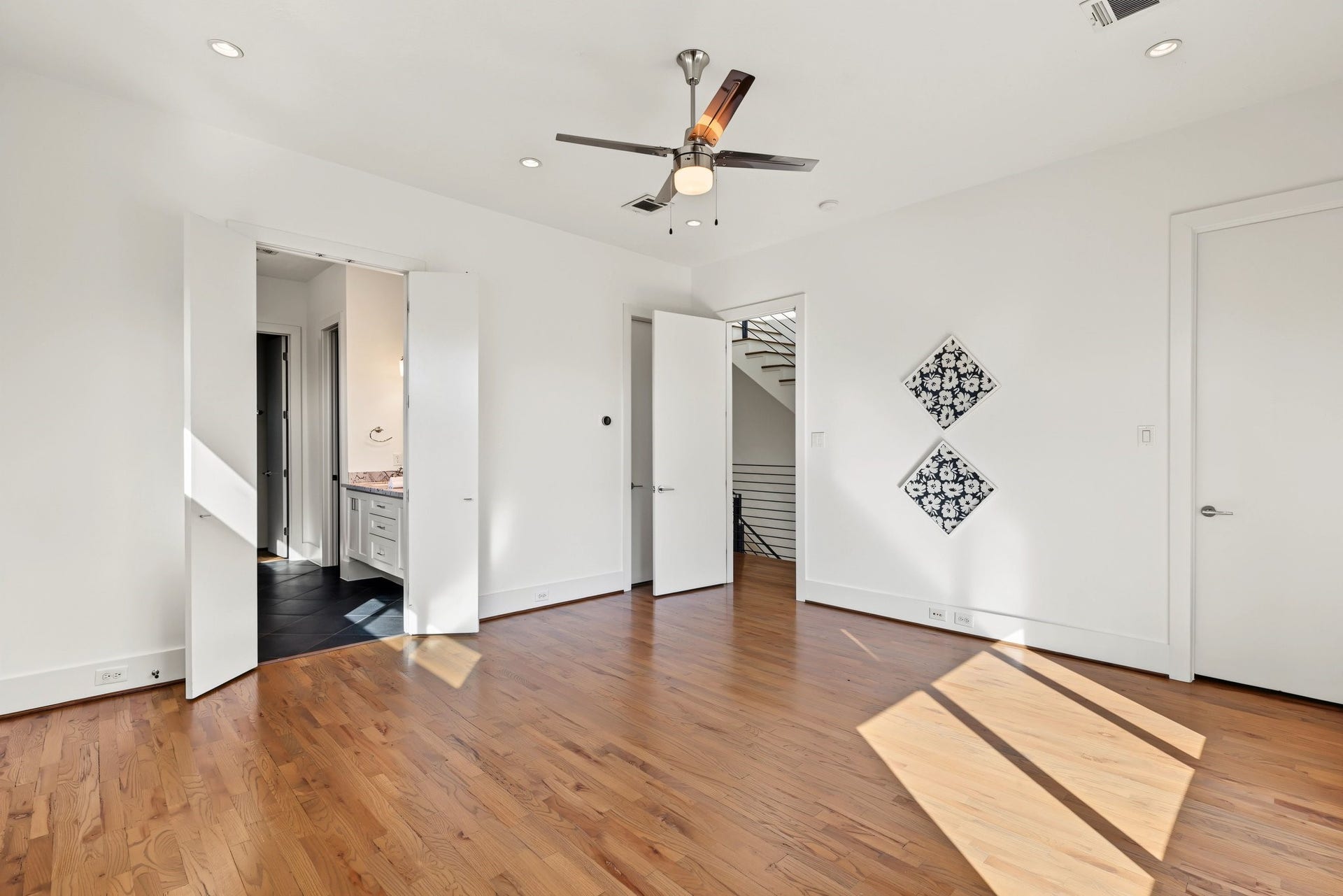 Sunlit and serene, this primary suite features warm white oak flooring and an elevated window design that maximizes natural daylight while keeping wall space open for your ideal bedroom layout.