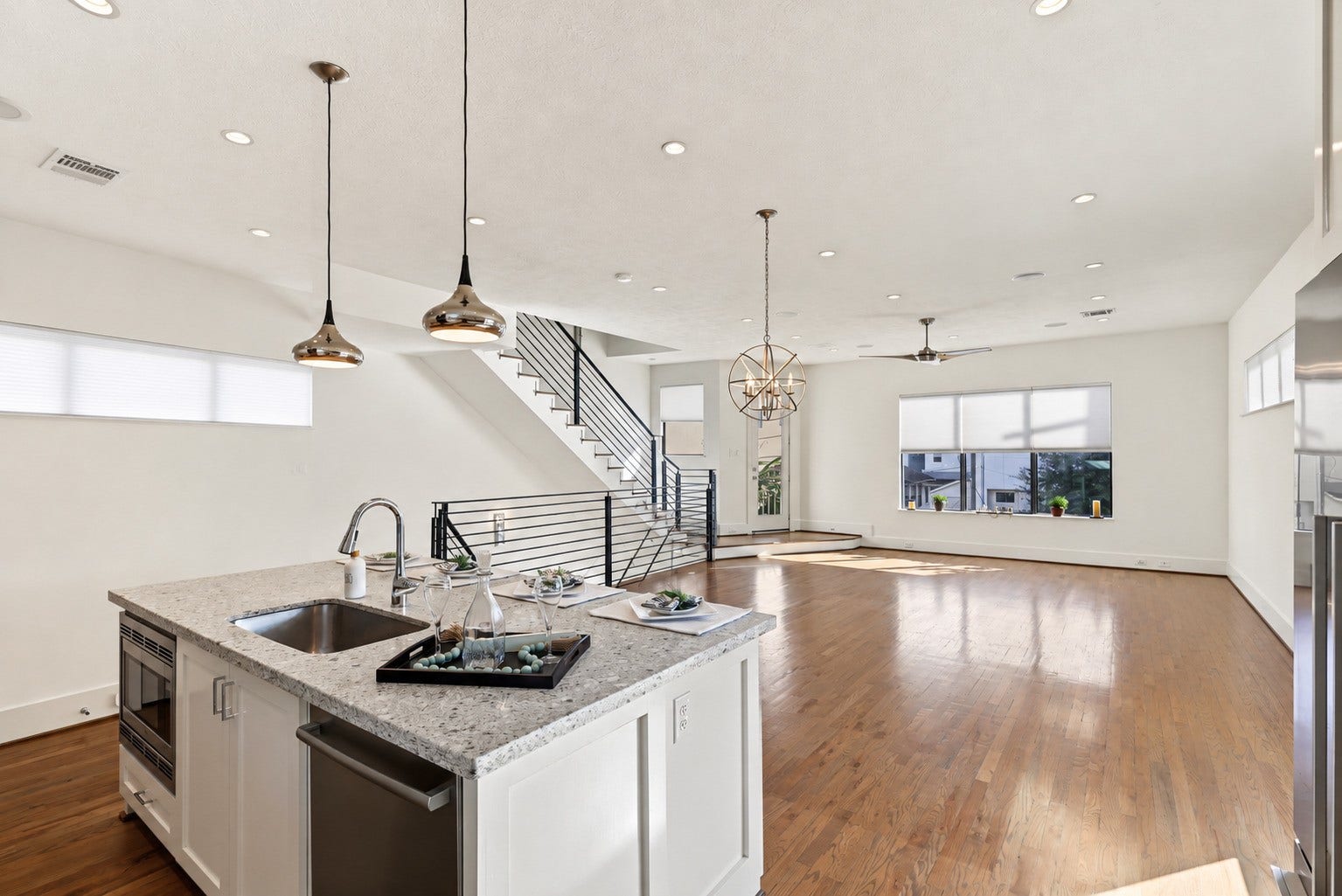At the center of the kitchen, a sleek quartz island effortlessly brings meal prep and conversation together. Illuminated by designer pendant lighting, the integrated breakfast bar and seamless flow to the living area ensure the chef remains right in the middle of the gathering.