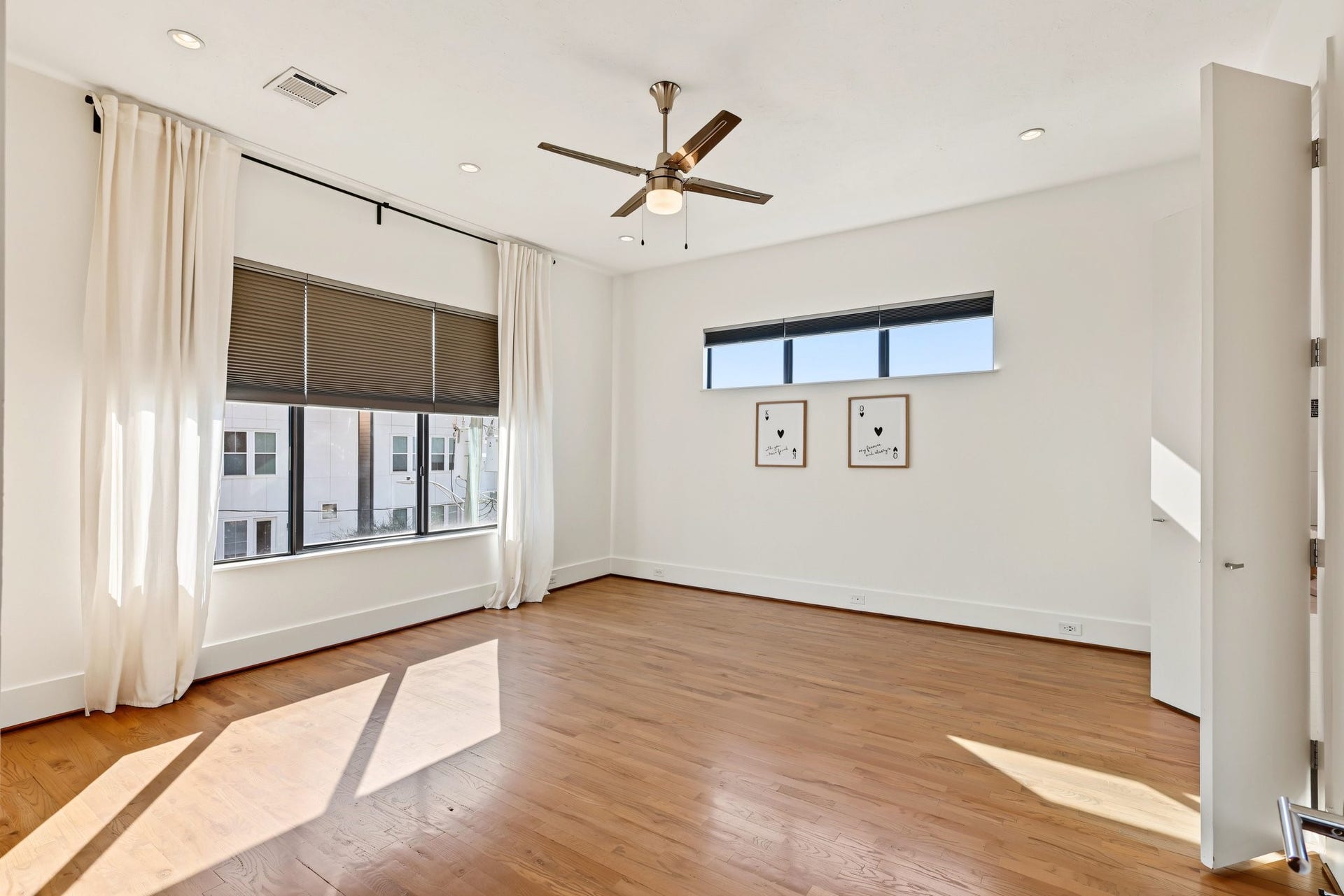 Unwind in a light-filled primary suite defined by warm solid white oak flooring and an airy, restful atmosphere. Dual walk-in closets provide generous, everyday storage to keep your retreat clutter-free, while sweeping views of the downtown skyline provide a dramatic backdrop from morning to night.