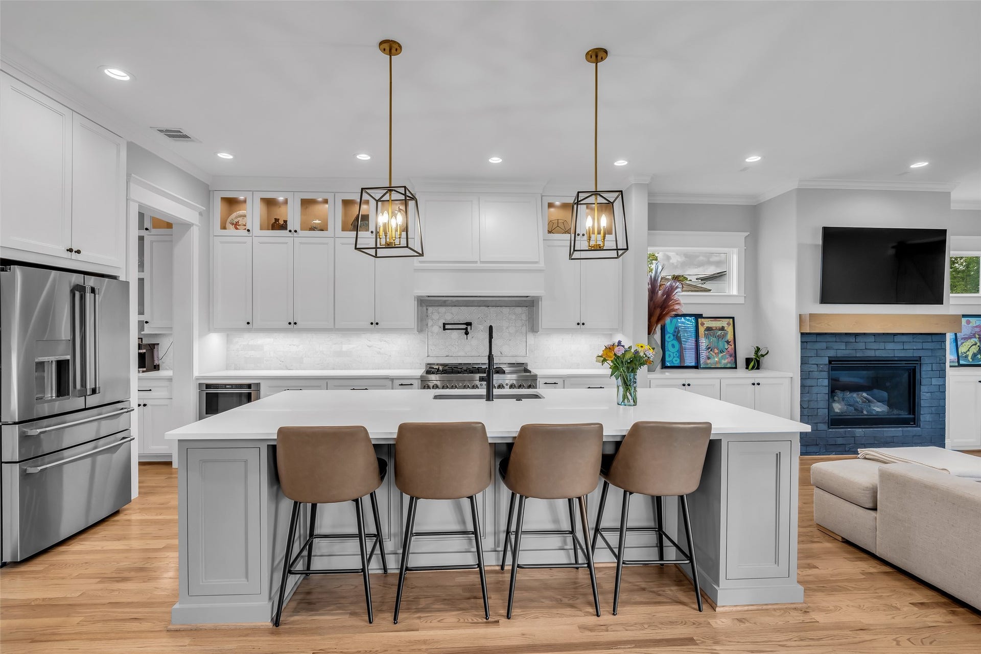 800 Walton Street, Houston, TX 77009 Full view of the kitchen highlights stylish droplights hanging above the island, adding both charm and focused lighting for meal prep and dining.
