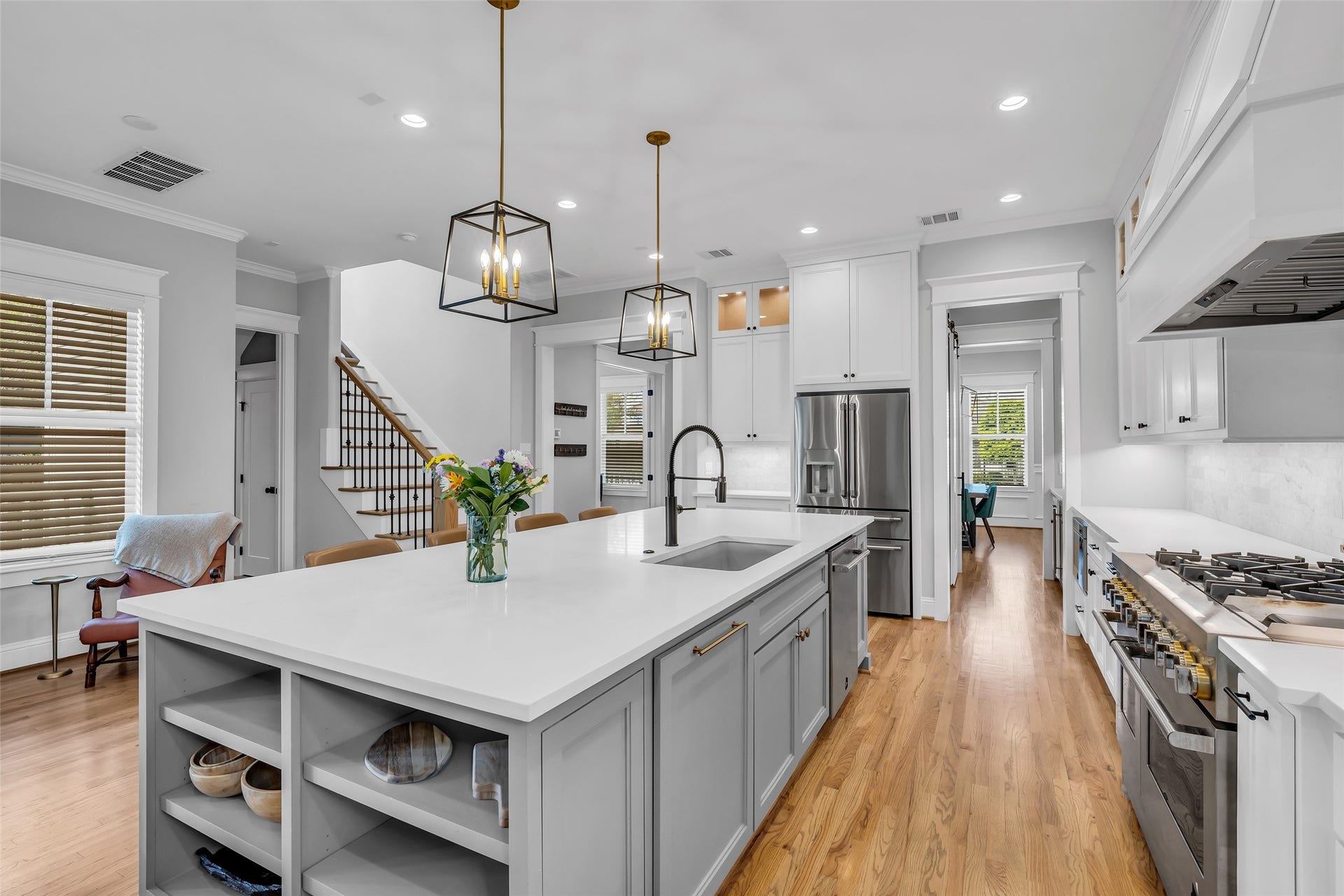 800 Walton Street, Houston, TX 77009 It features a spacious island with a built-in sink, providing ample workspace for food preparation and meal gatherings.