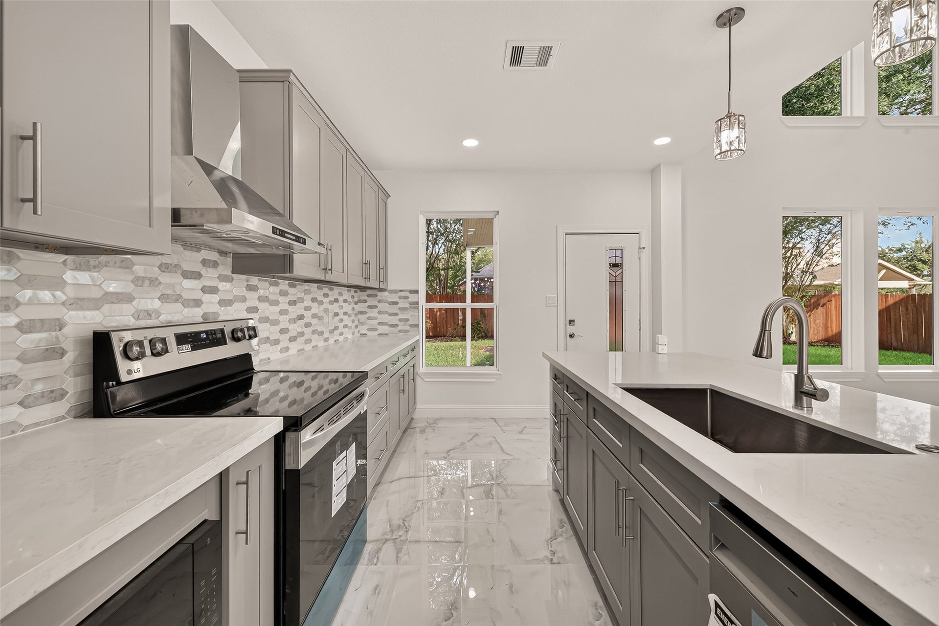 2111 Pinecreek Pass Lane, Katy, TX 77449 Kitchen view highlighting the long countertops, ample storage, and open connection to the living area.