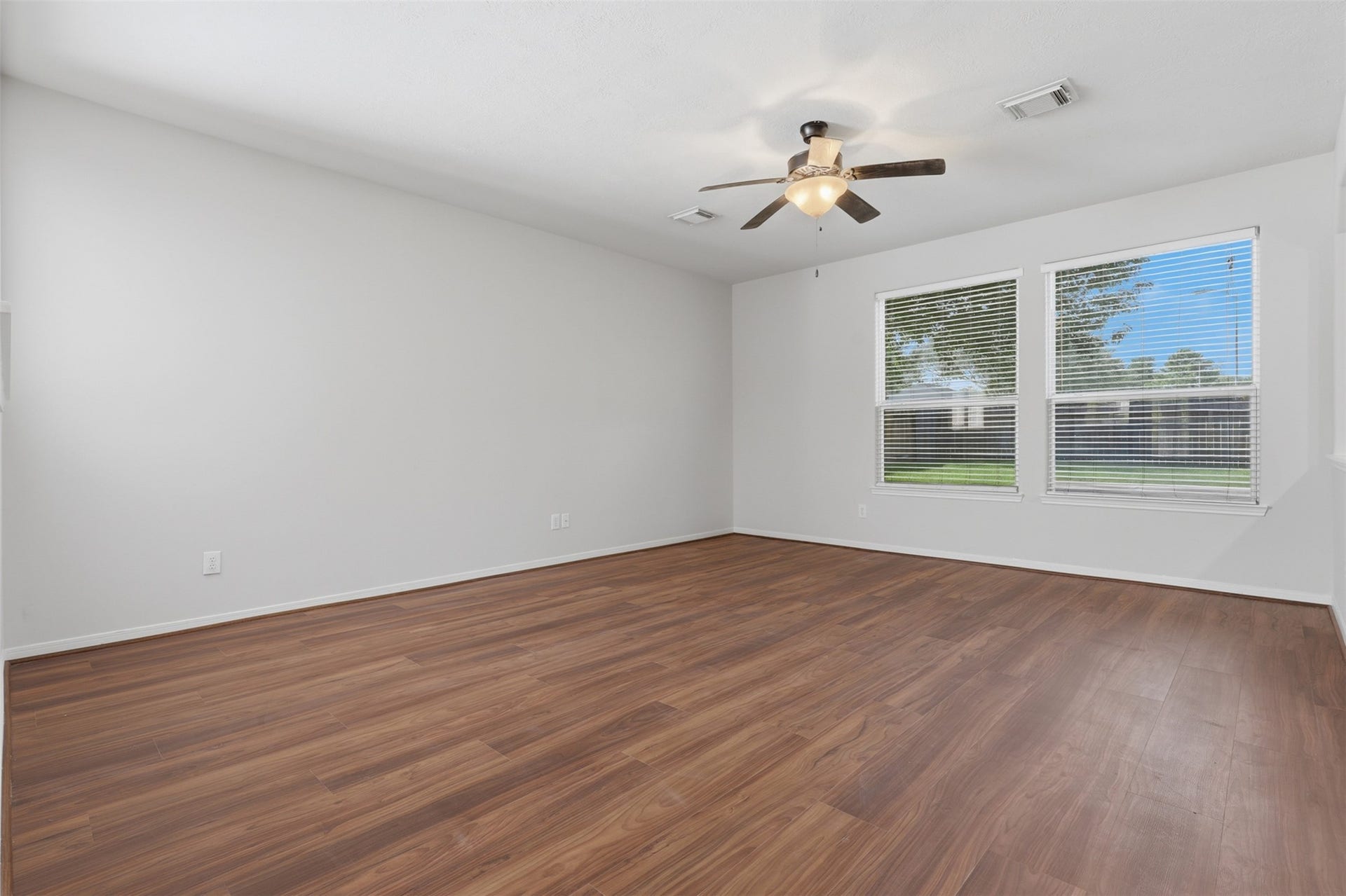 Bright and inviting family room featuring brand-new LVP flooring and fresh interior paint.