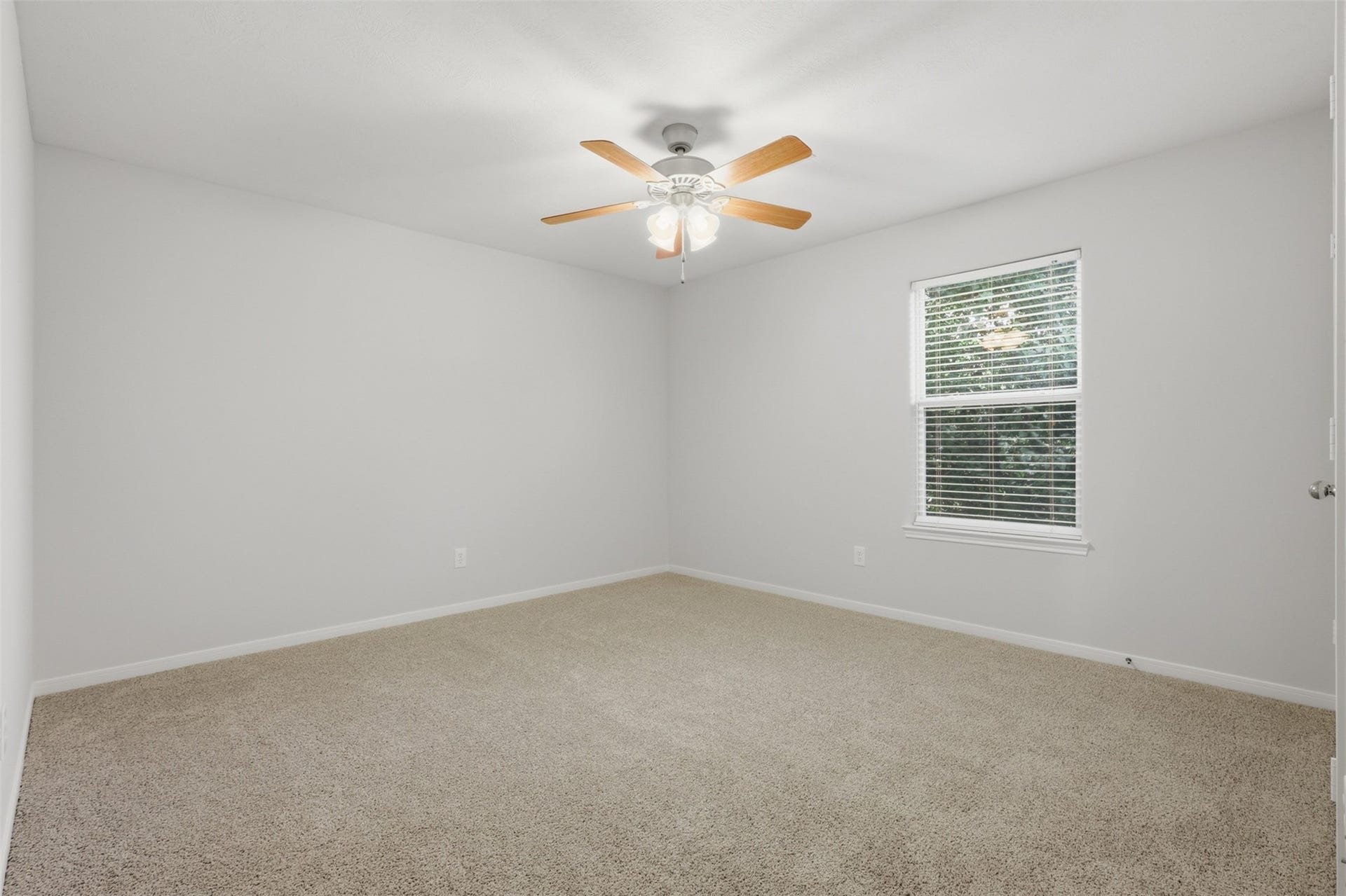 Secondary bedroom featuring fresh neutral paint that enhances the room's bright natural light, offering plenty of space for your furnishings.