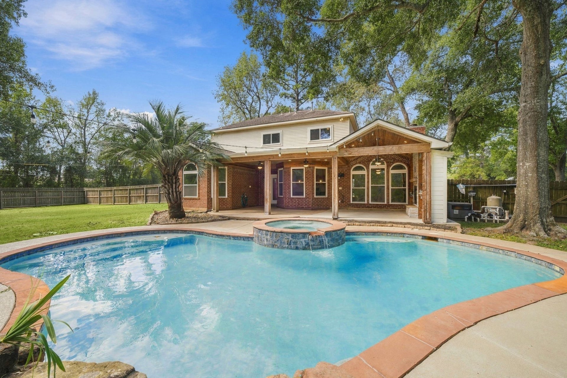 1065 Heritage Lane, Conroe, TX 77304 Look at this back yard! Sparkling pool, super cool covered patio with outdoor kitchen and fireplace all on an approximate half acre lot!
