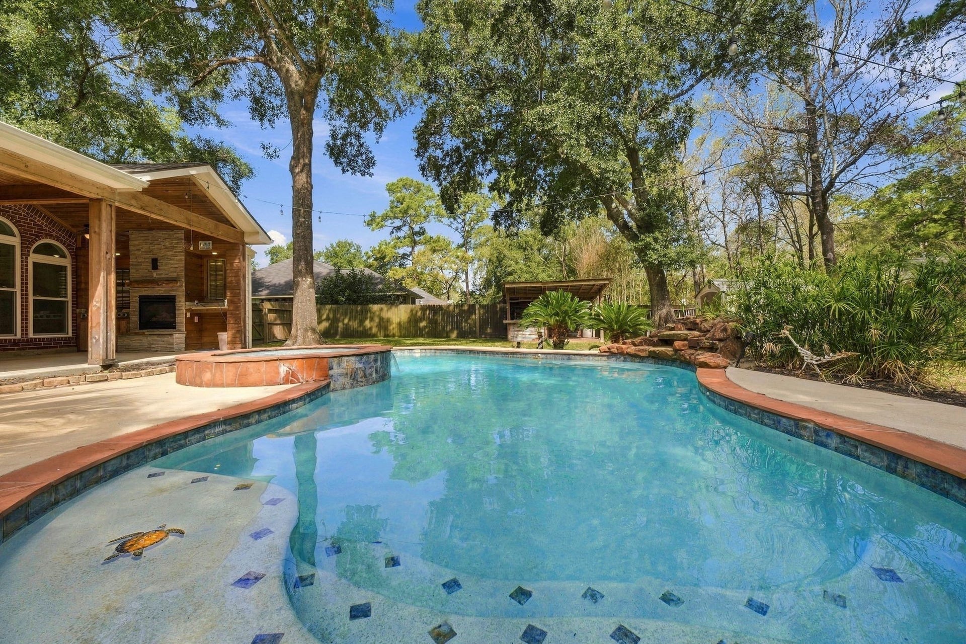 1065 Heritage Lane, Conroe, TX 77304 From the pool you can see the covered patio with outdoor kitchen and fireplace!