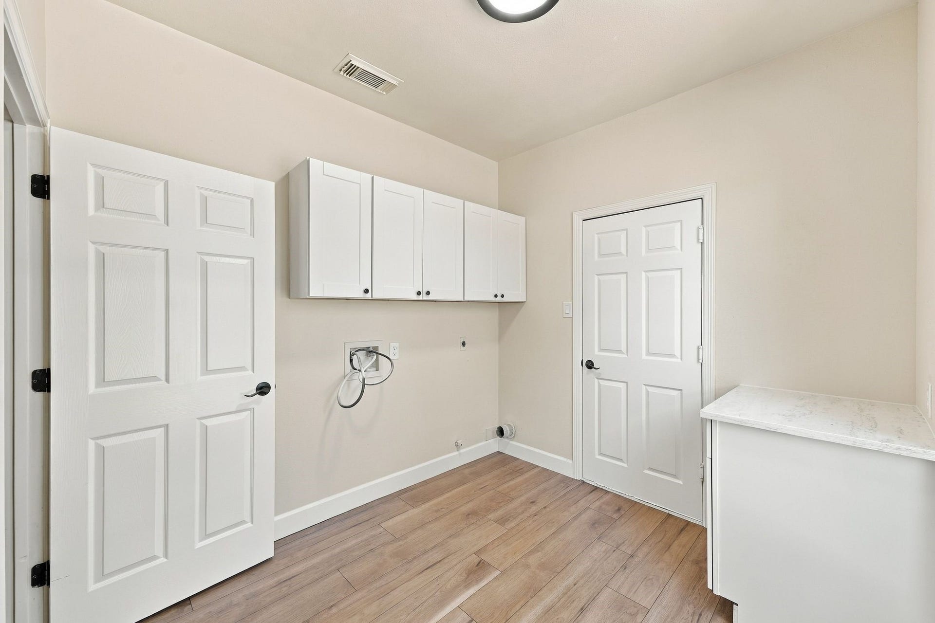 1065 Heritage Lane, Conroe, TX 77304 The laundry room is located just off of the entrance to the home from the garage. So roomy with storage and a folding counter!