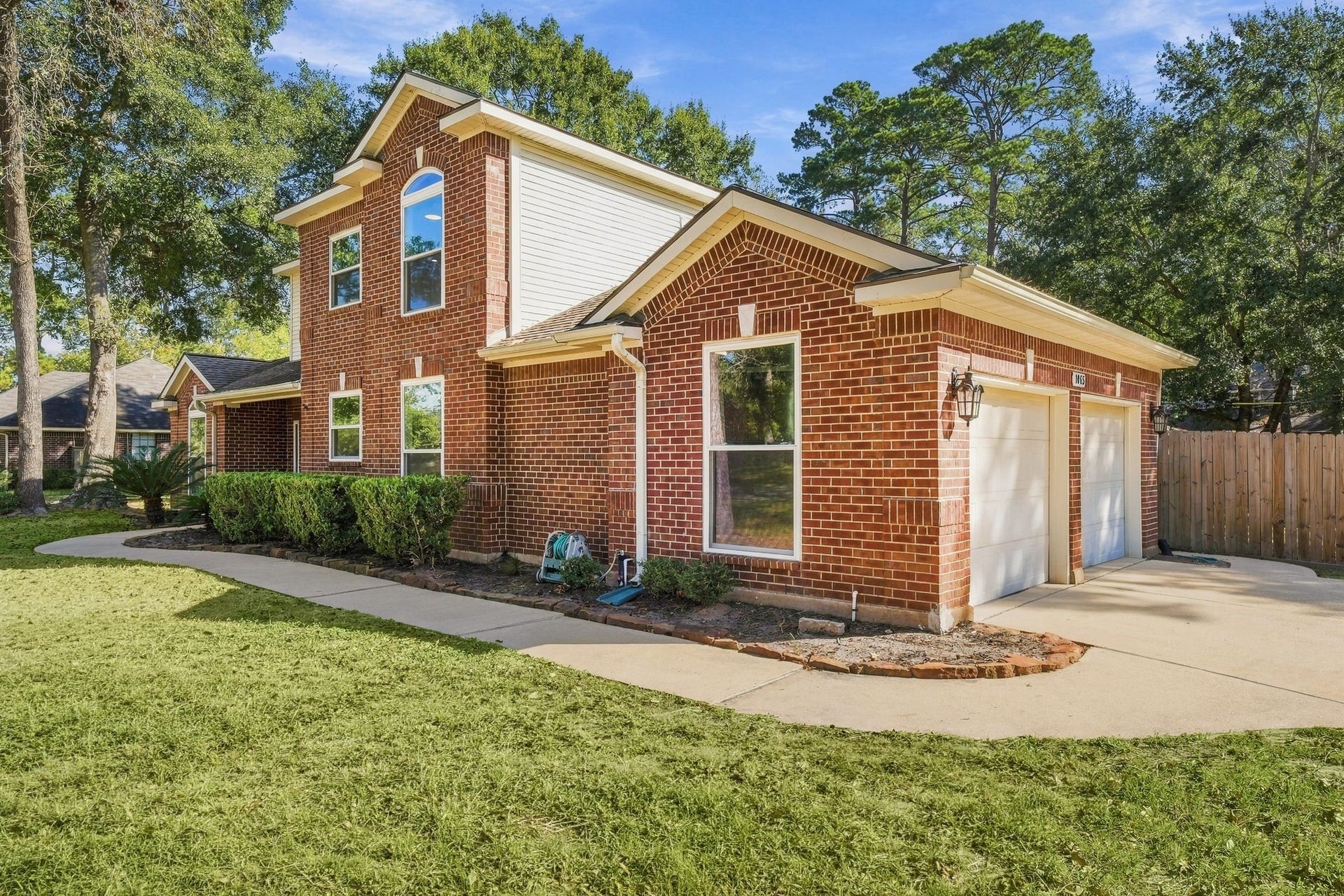 1065 Heritage Lane, Conroe, TX 77304 Two car attached garage with a double driveway near the garage.